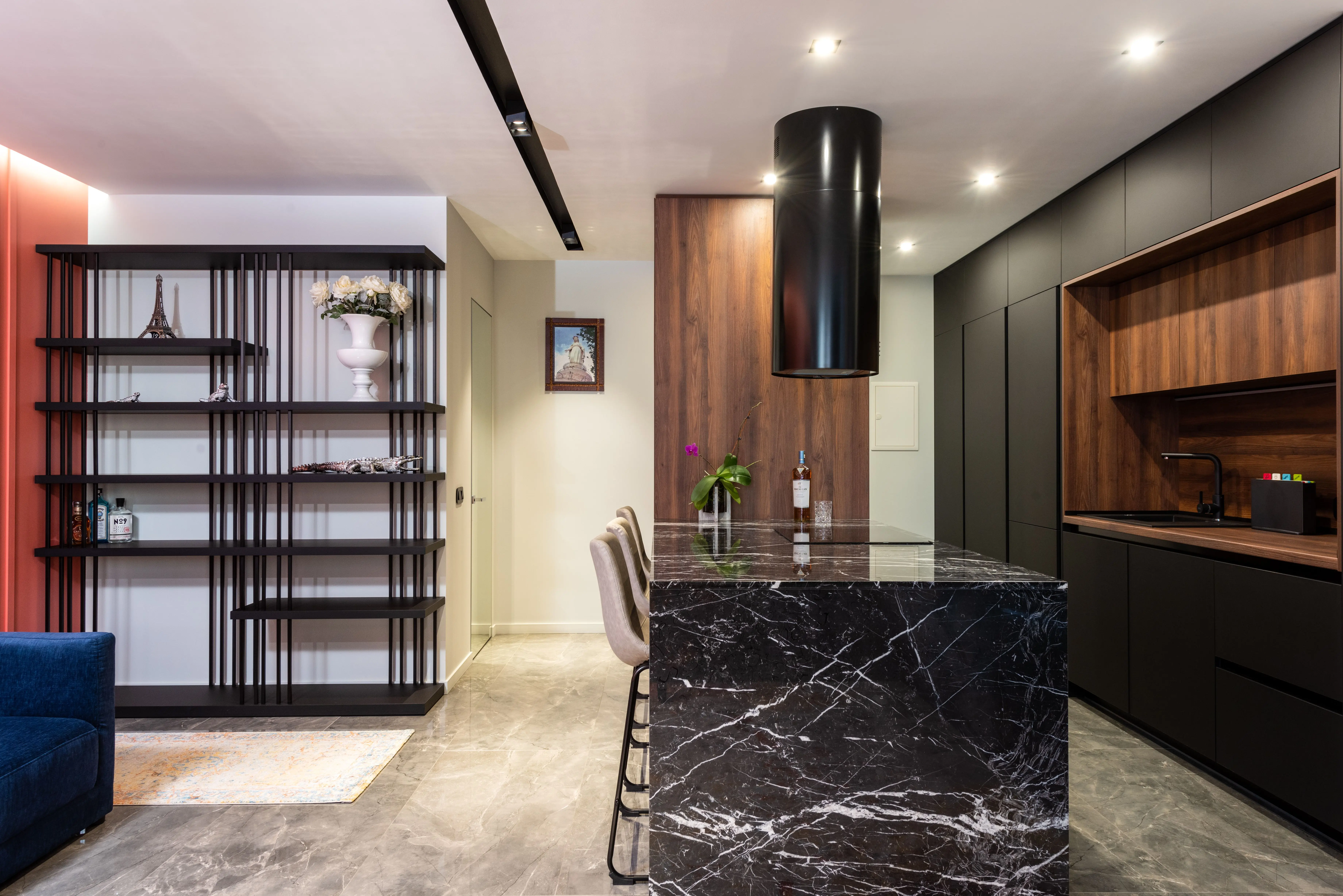 black backsplash Modern kitchen interior with black marble island and wooden cabinets, featuring a sleek design.