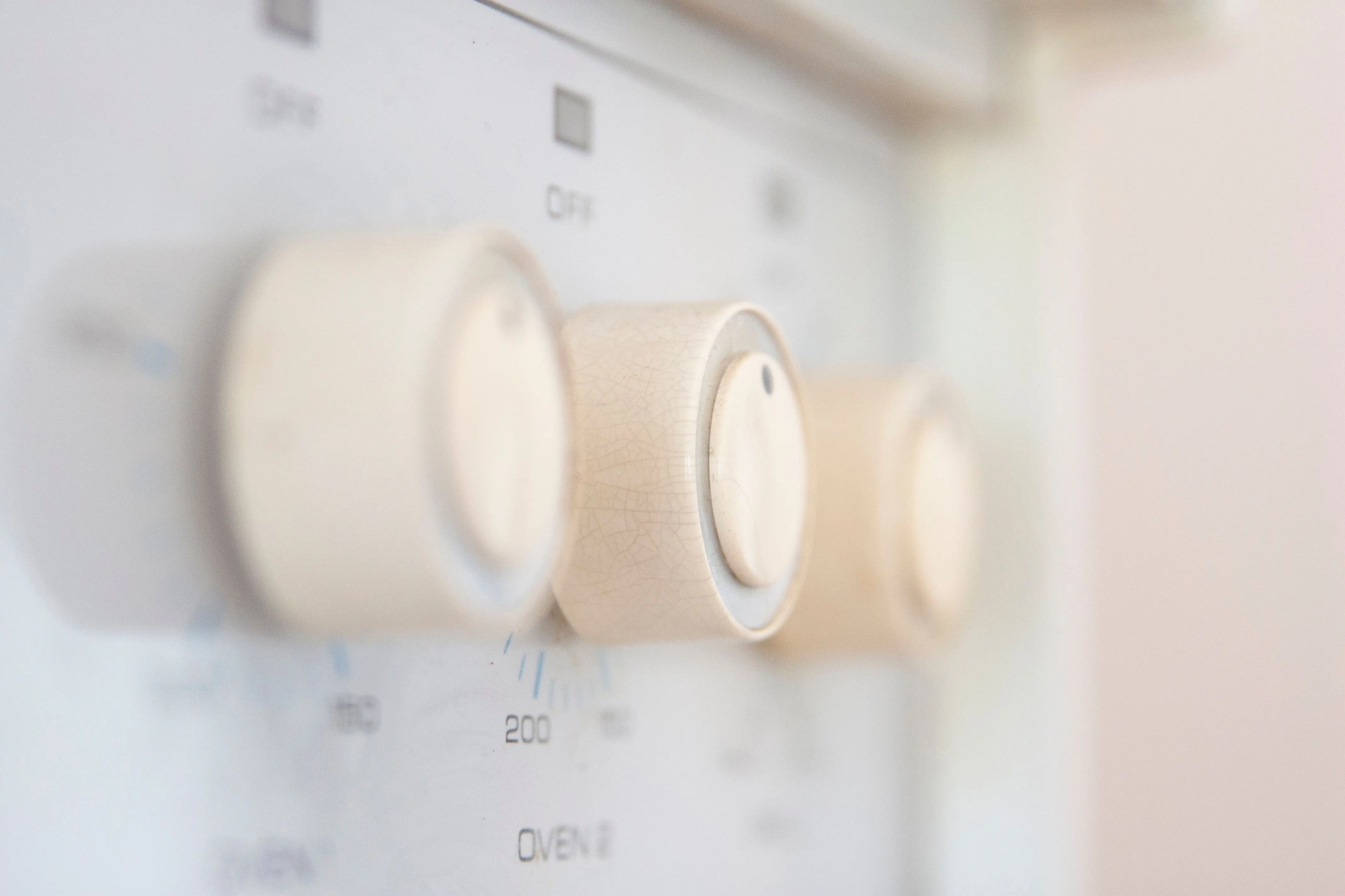 black cabinet knobs Artistic close-up of stove control knobs, highlighting design details in a kitchen setting.