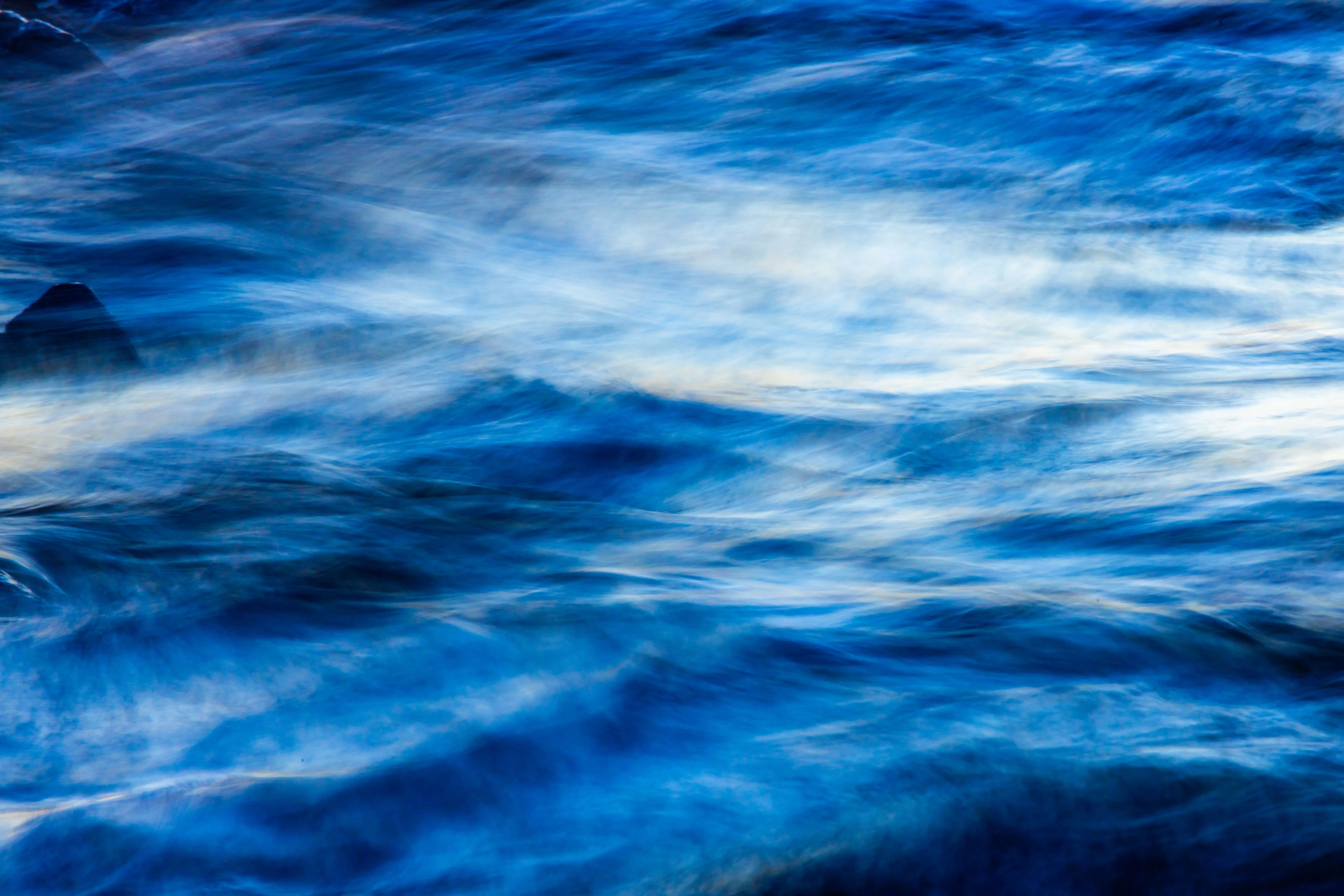 coastal wall decor Vibrant abstract image of blue ocean waves flowing gracefully.