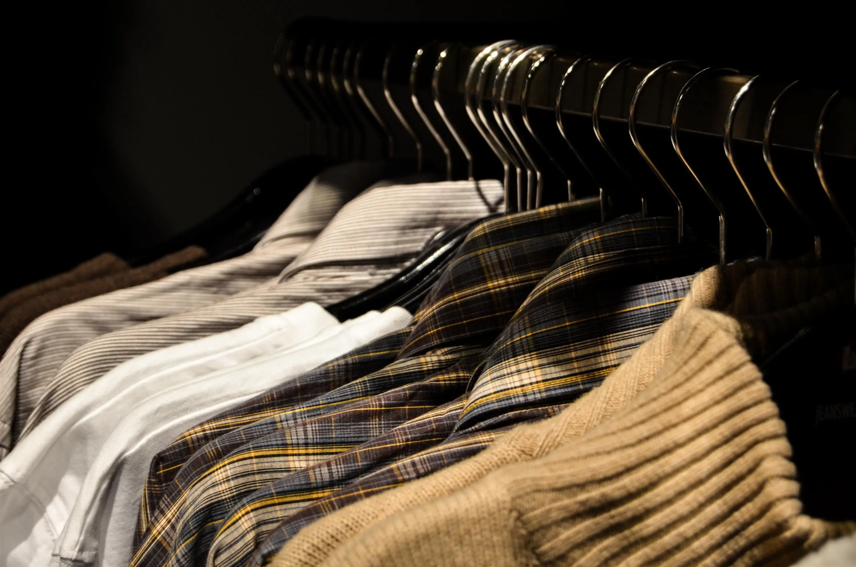 closet rod height Organized display of various shirts on hangers, showcasing fashion and style.