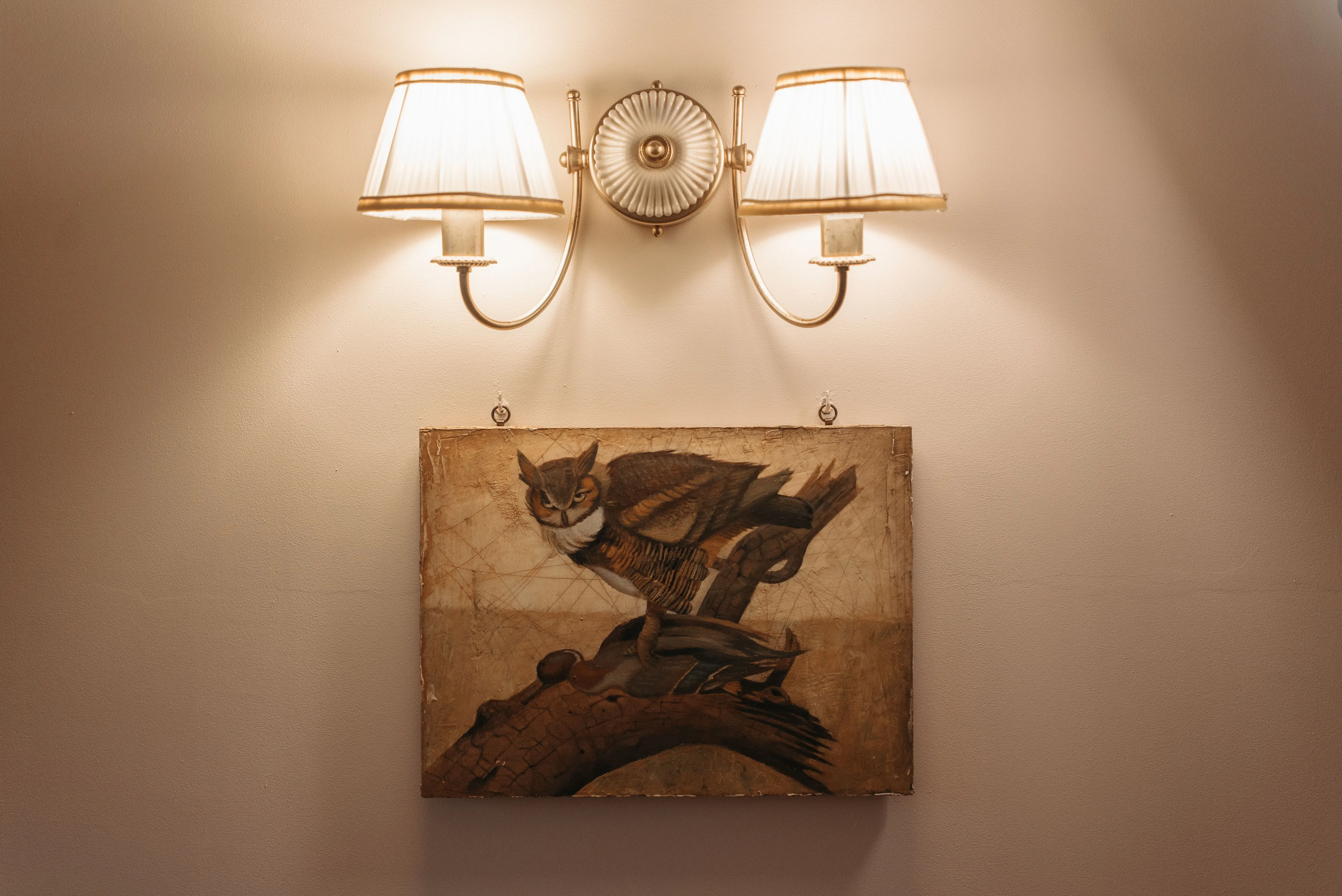 sconce outdoor wall light Vintage painting with dual sconces on a neutral wall for elegant decor inspiration.
