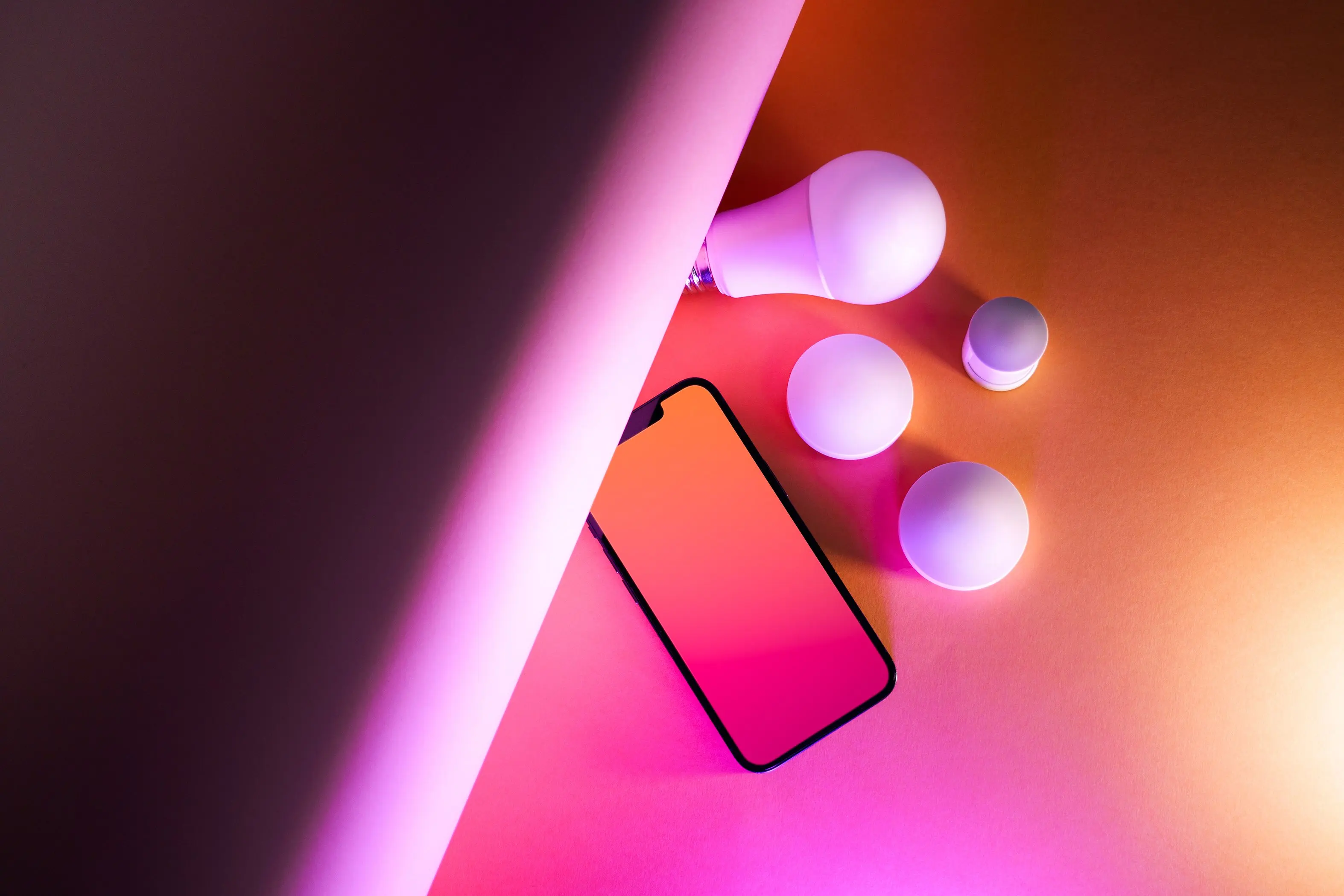 wall lamp outdoor Vibrant artistic composition of smart home bulbs and smartphone on a gradient background.
