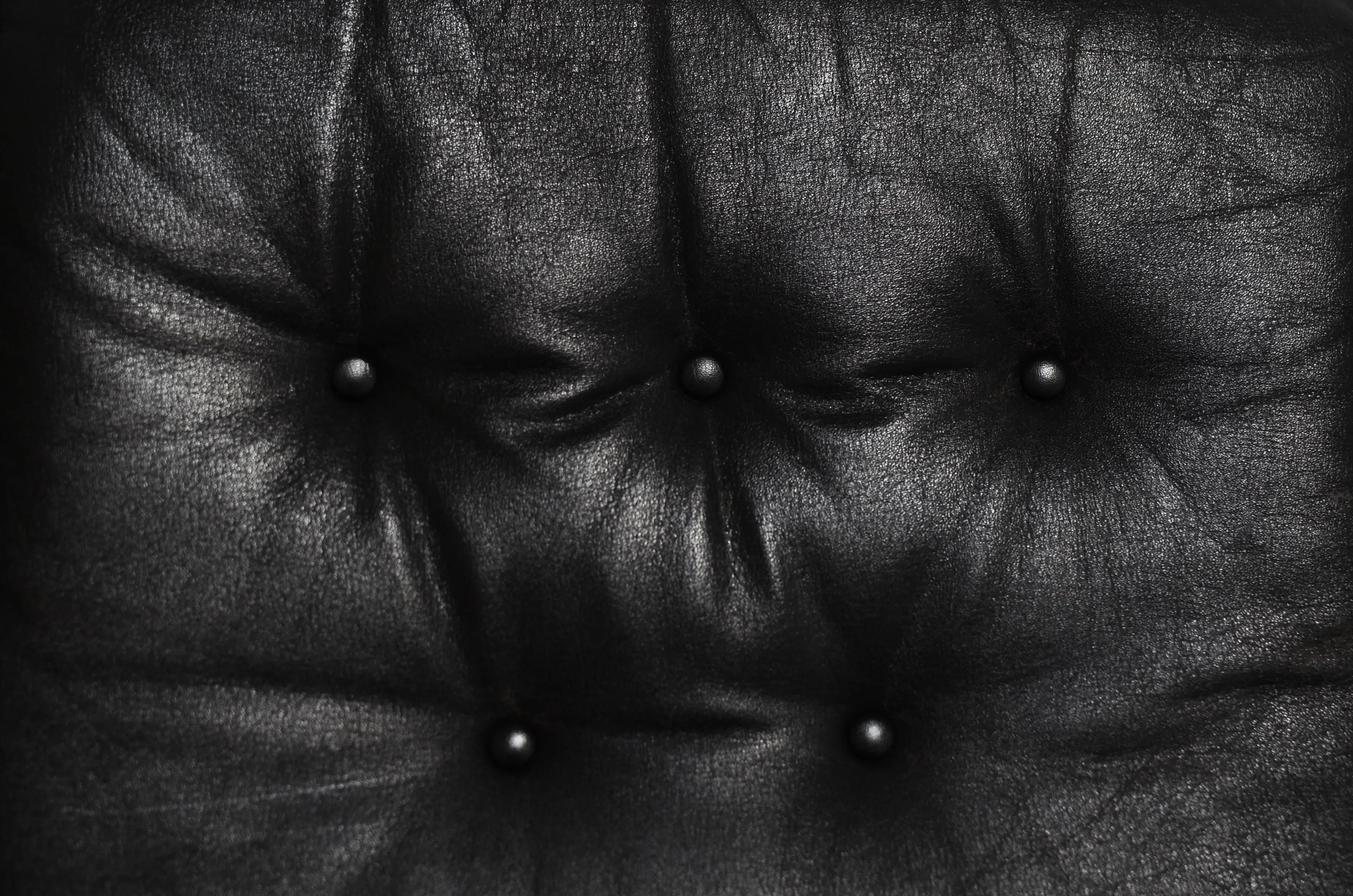 sectional green Abstract textured background of old weathered tufted couch cushion of black leather with small buttons