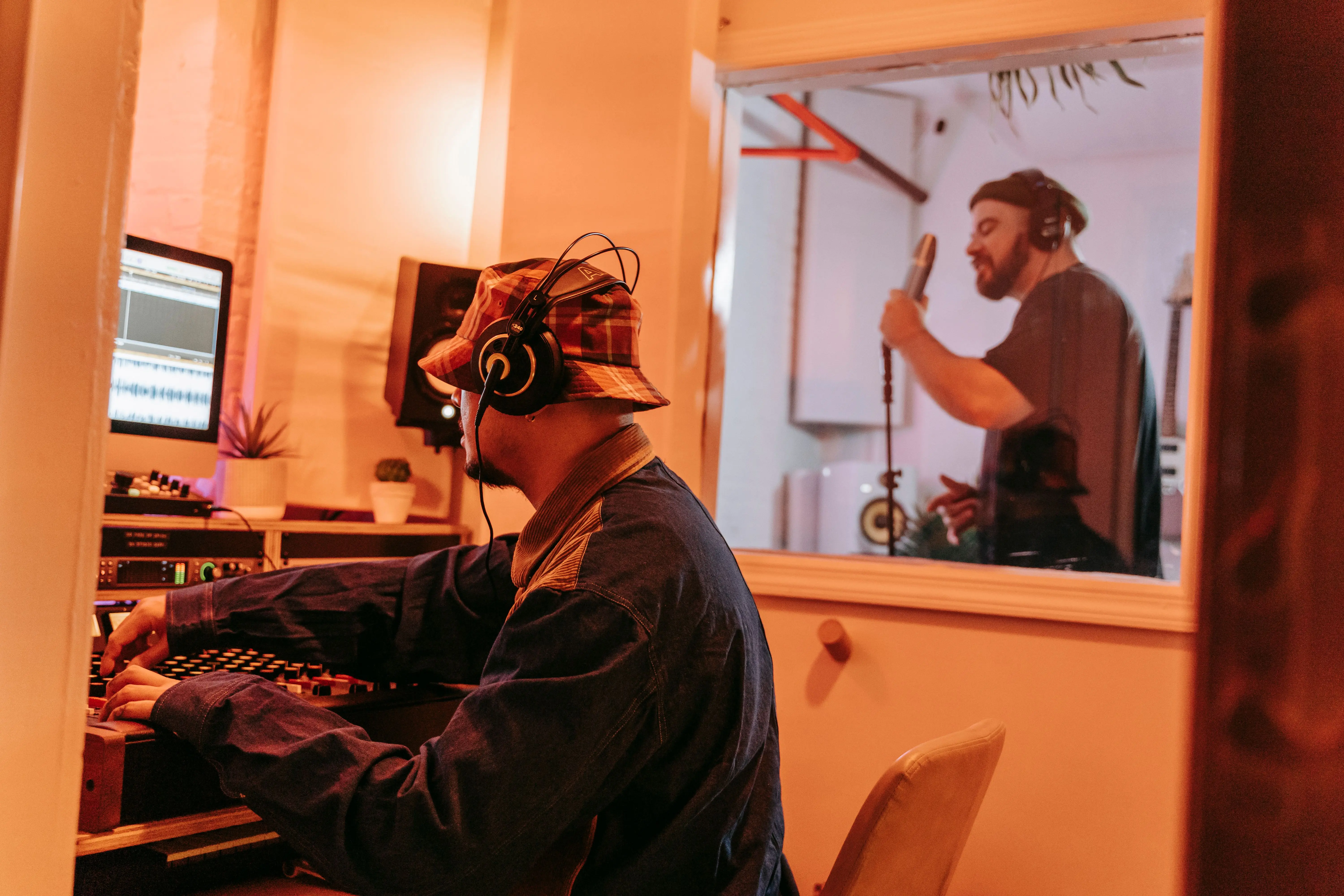 studio room ideas Producer and singer in a professional music studio, collaborating on a recording session.