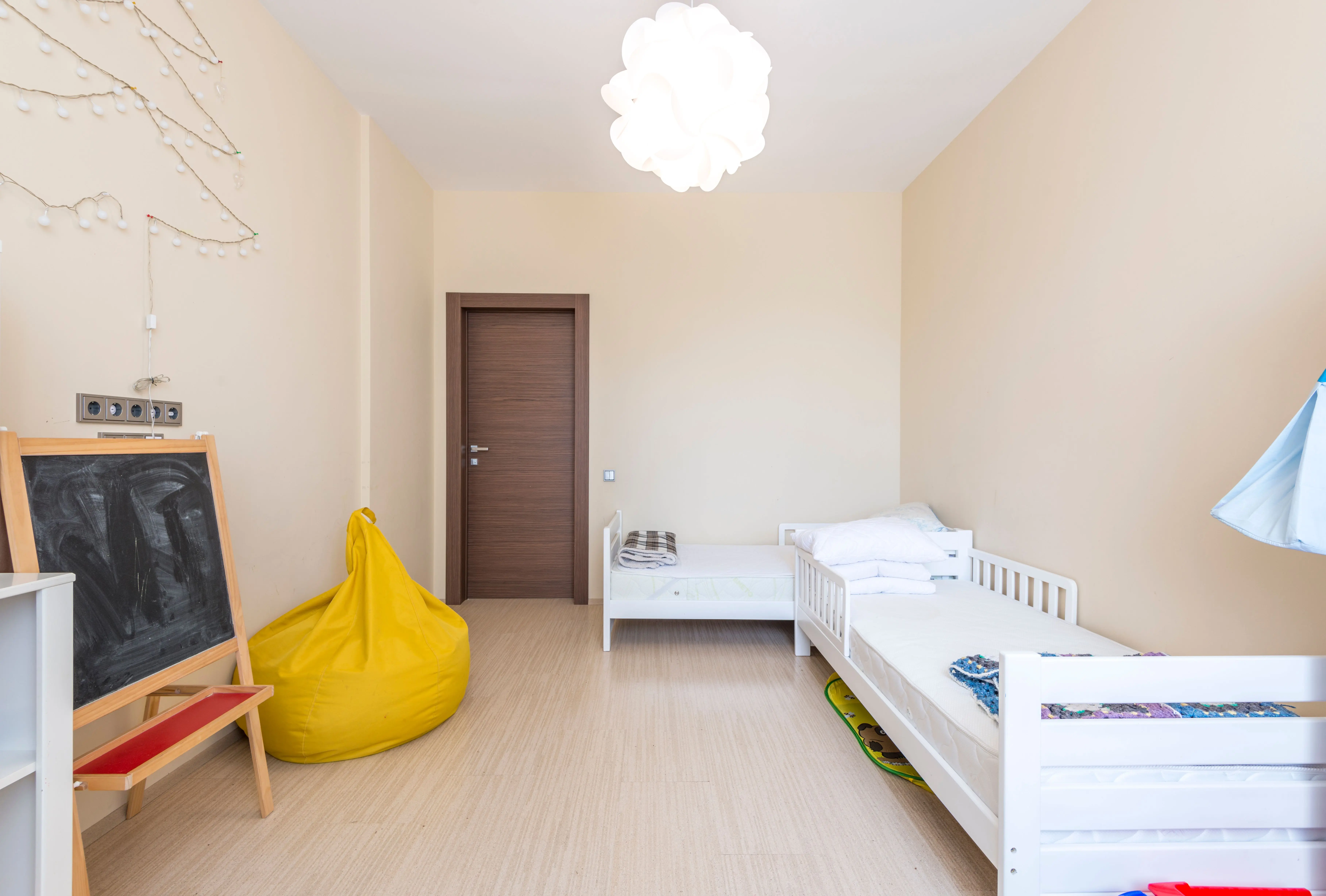 twin platform bed with storage Bright and cozy children's bedroom featuring twin beds and minimalist decor.