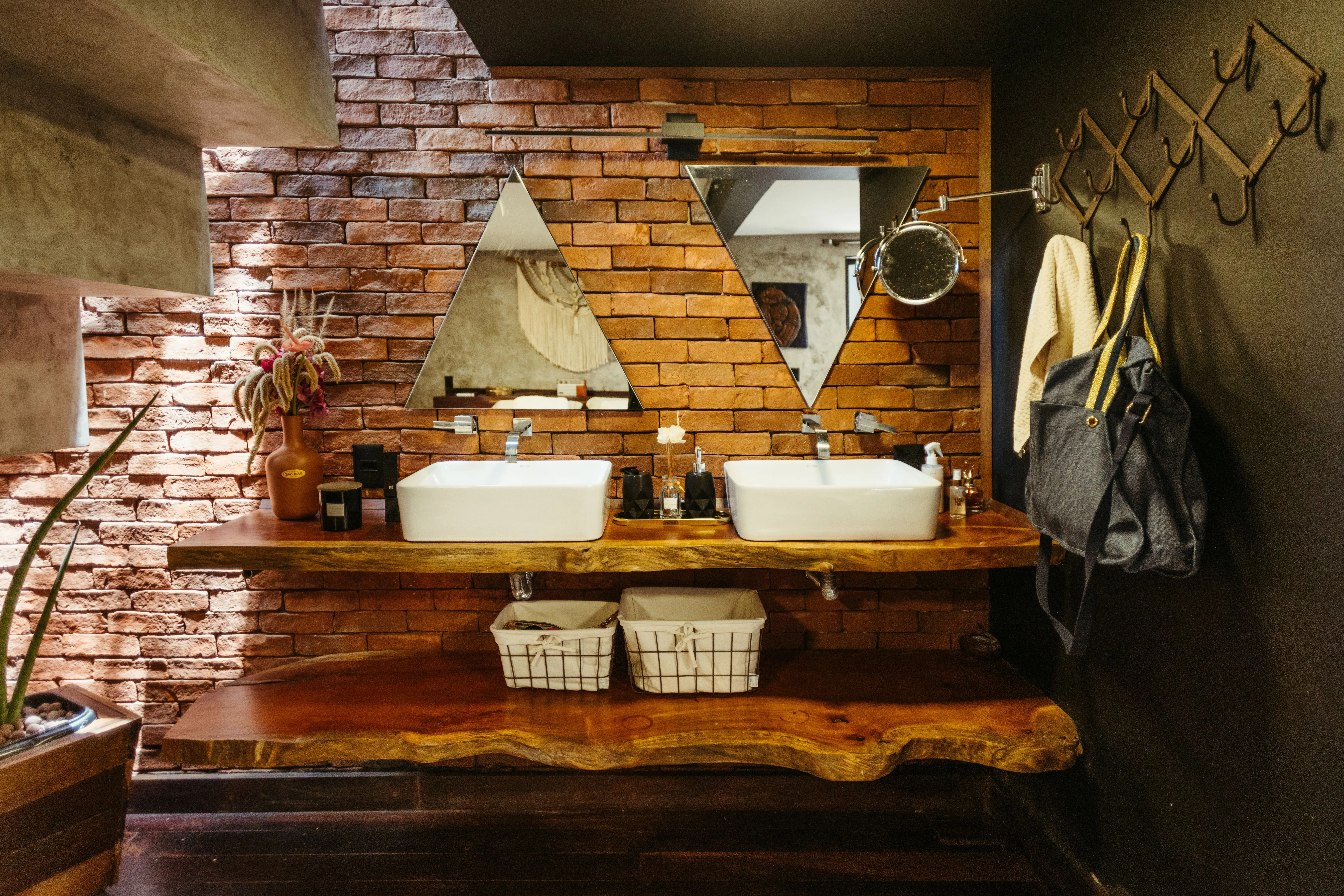 wood bathroom vanities A stylish rustic bathroom featuring brick walls, wood elements, and modern fixtures, creating a unique charm.