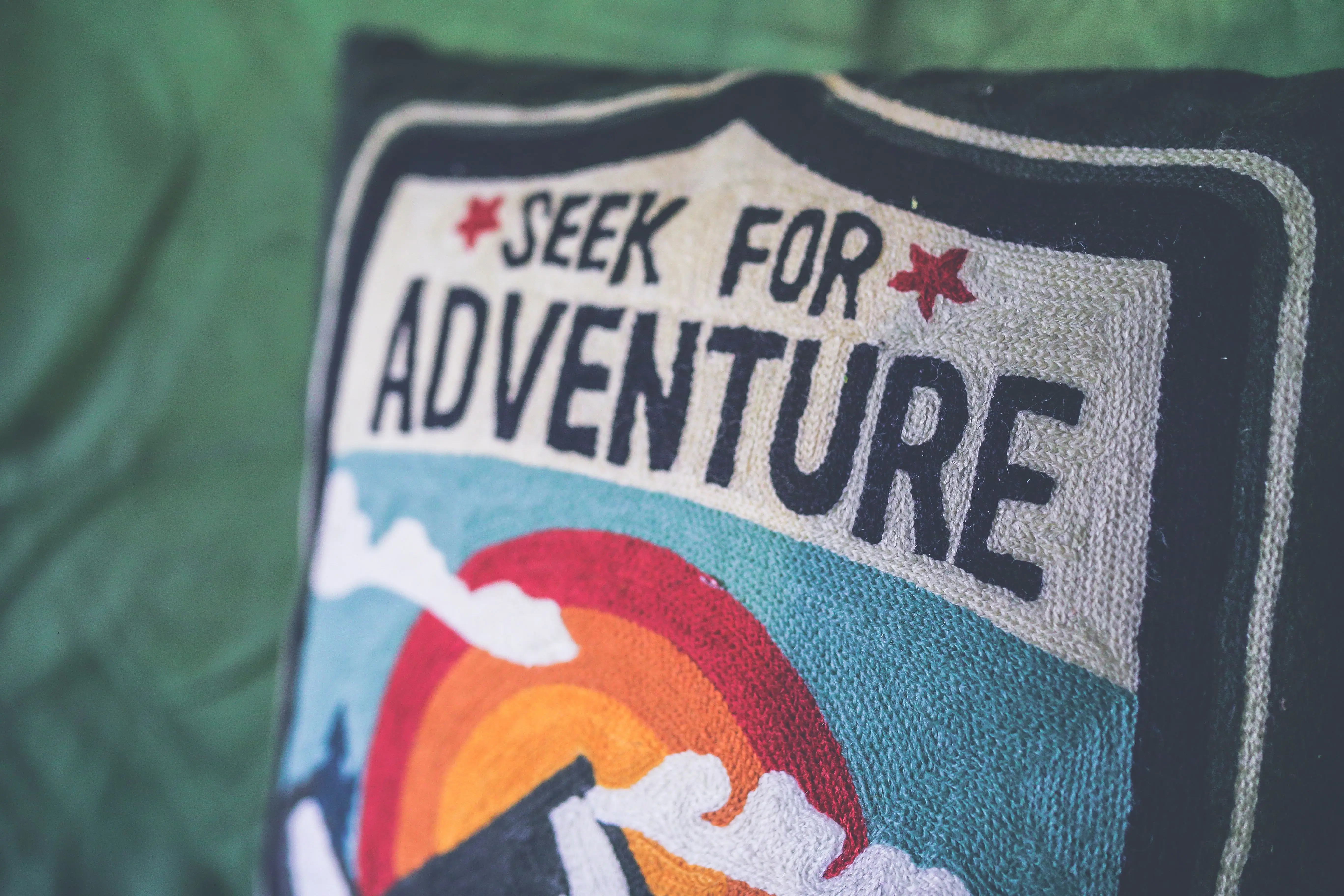white pillow Colorful pillow with 'Seek for Adventure' text, perfect for decor.