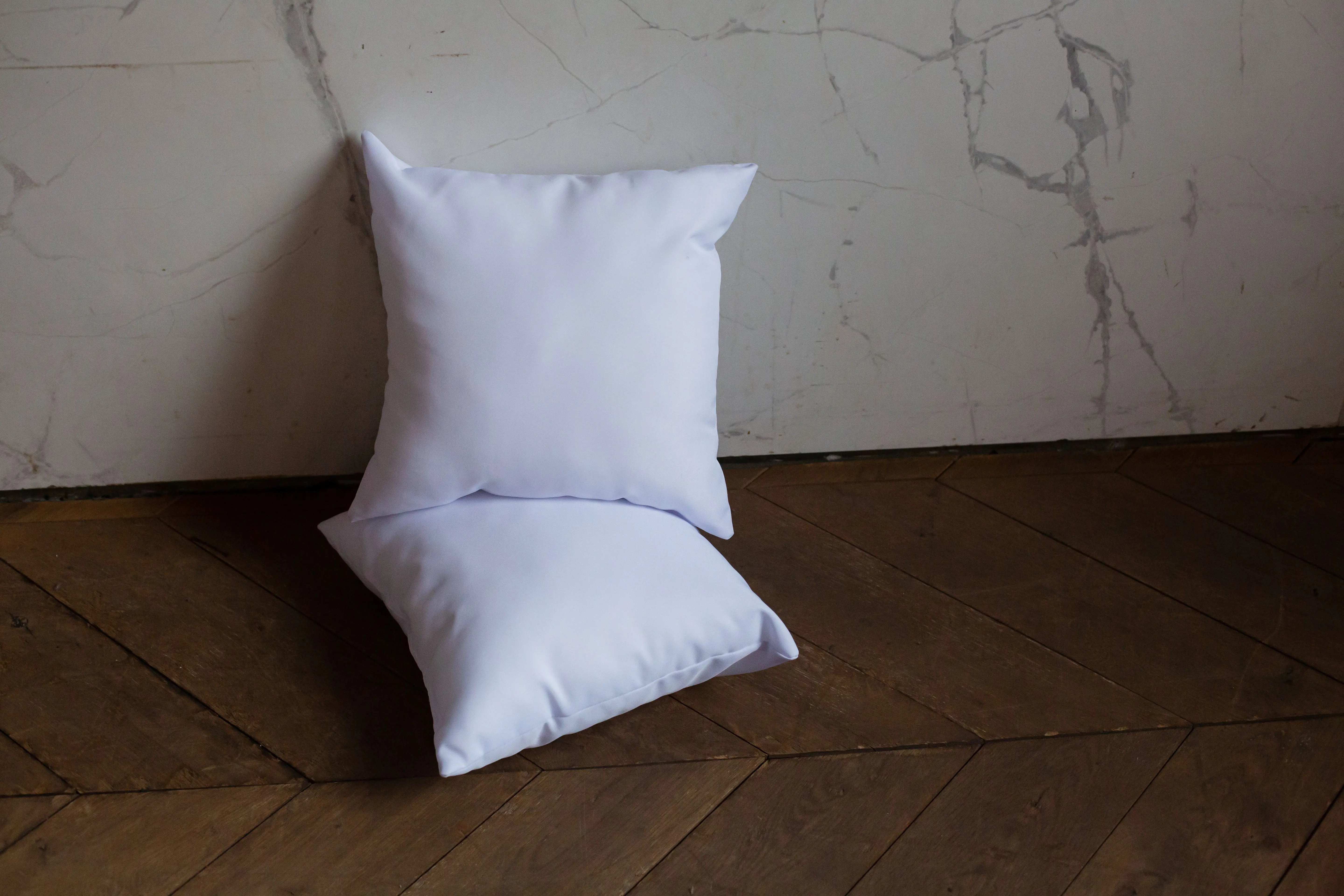 white pillow Minimalist design with white pillows on decorative wooden floor.