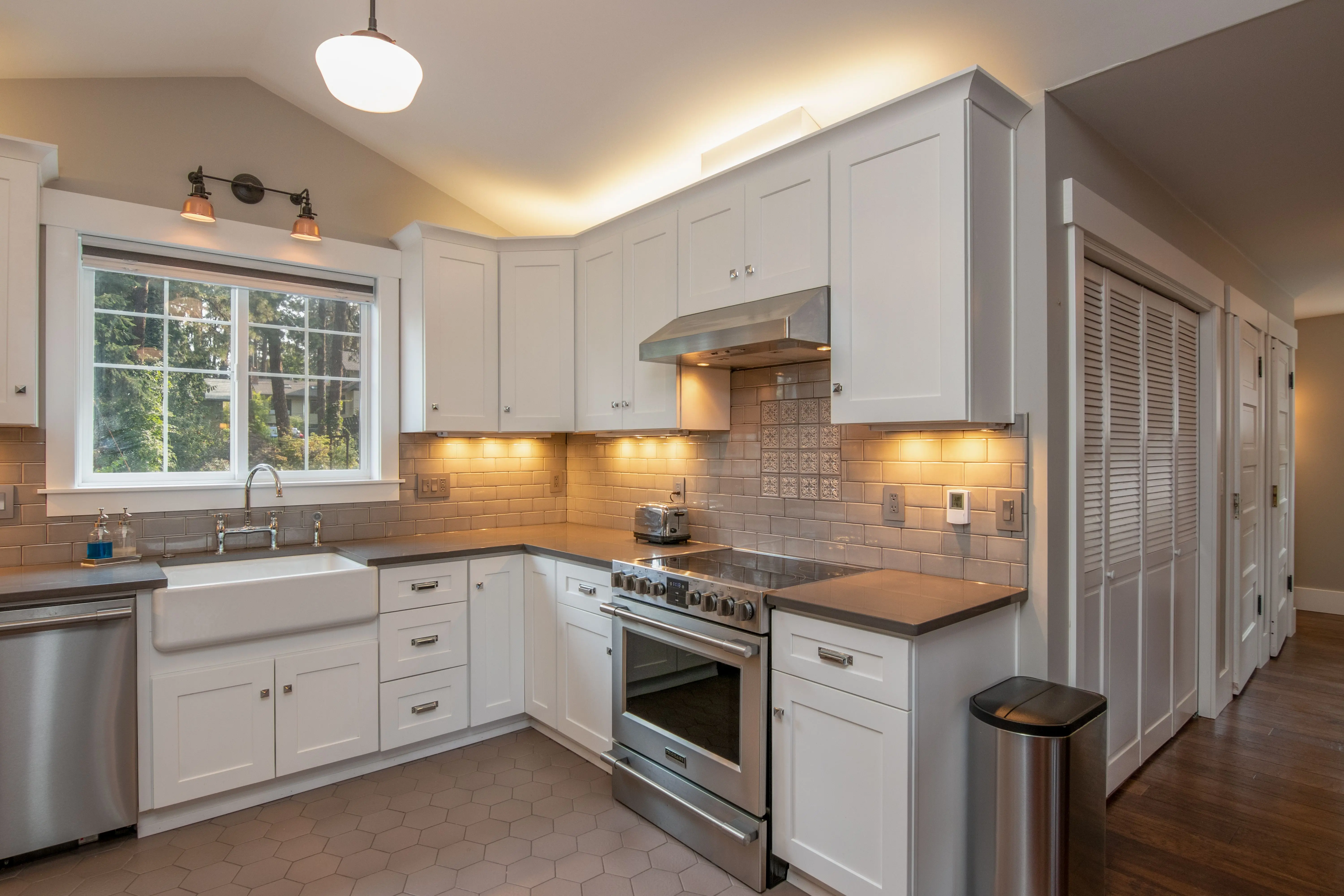 farmhouse kitchen cabinets Bright and spacious kitchen with white cabinetry and sleek appliances.