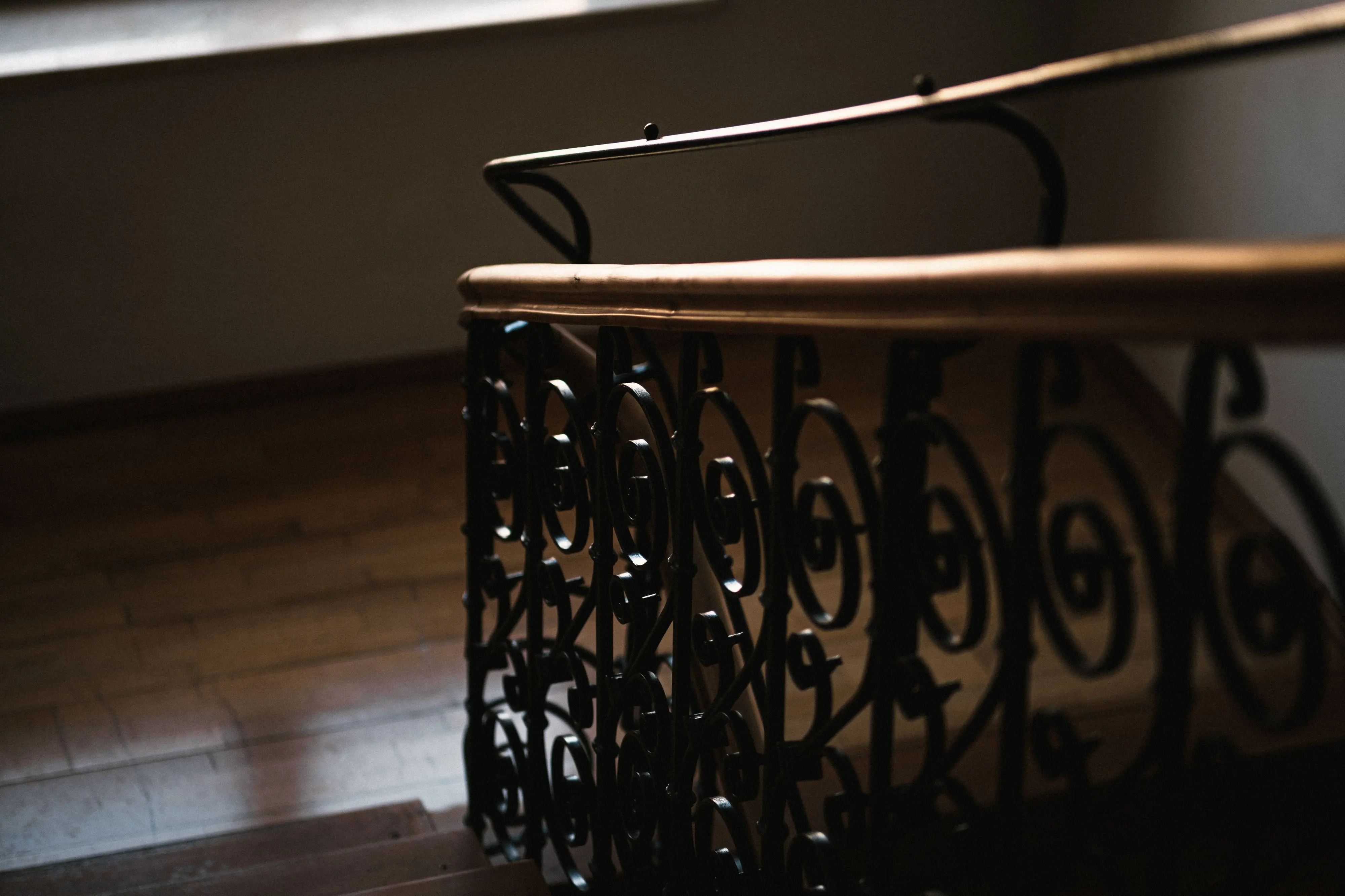 wrought iron patio furniture sets Close-up of a beautifully designed spiral staircase featuring ornate metal railing and wooden steps.