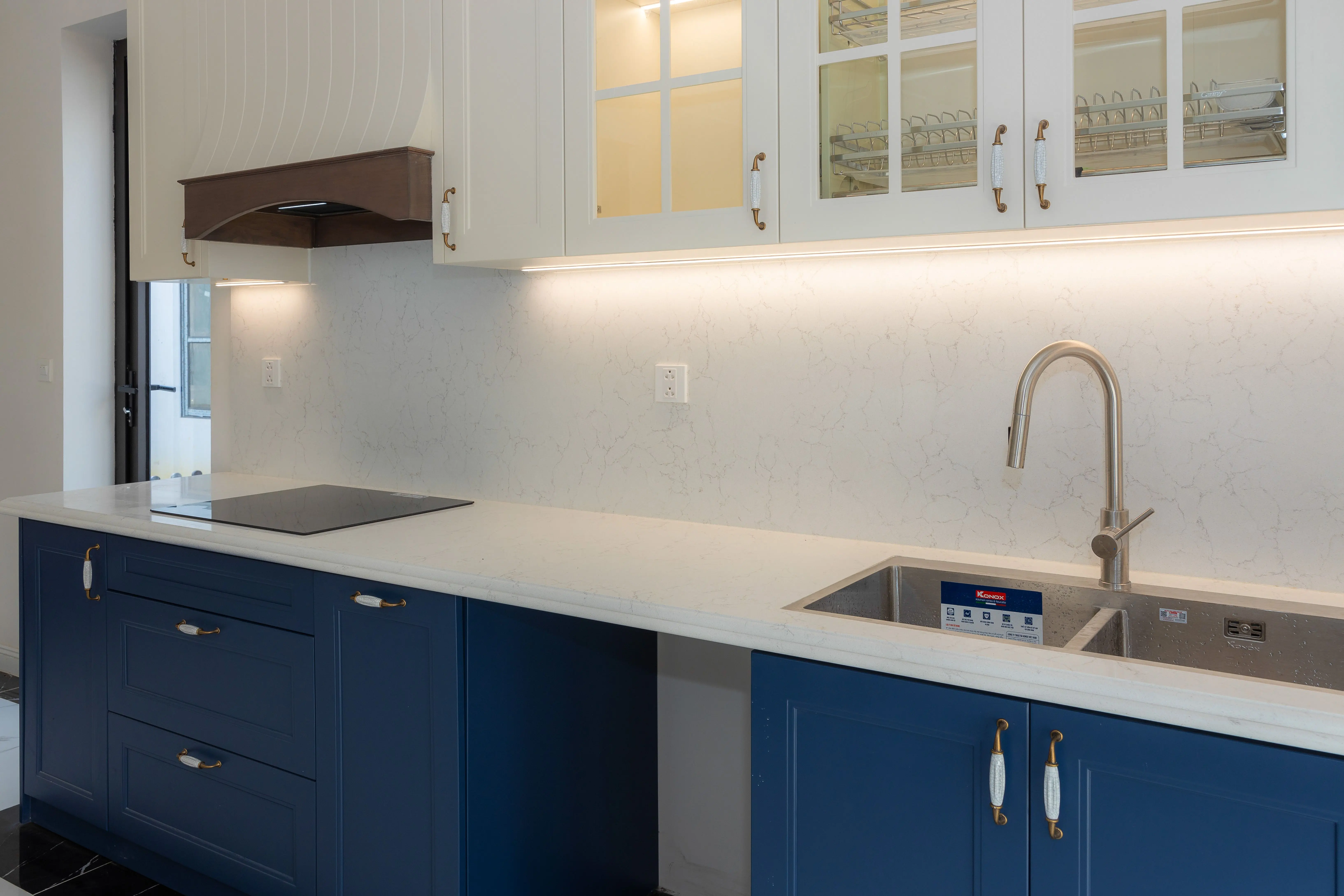 mdf cabinets Sleek kitchen featuring blue cabinets, white countertops, and modern fixtures.