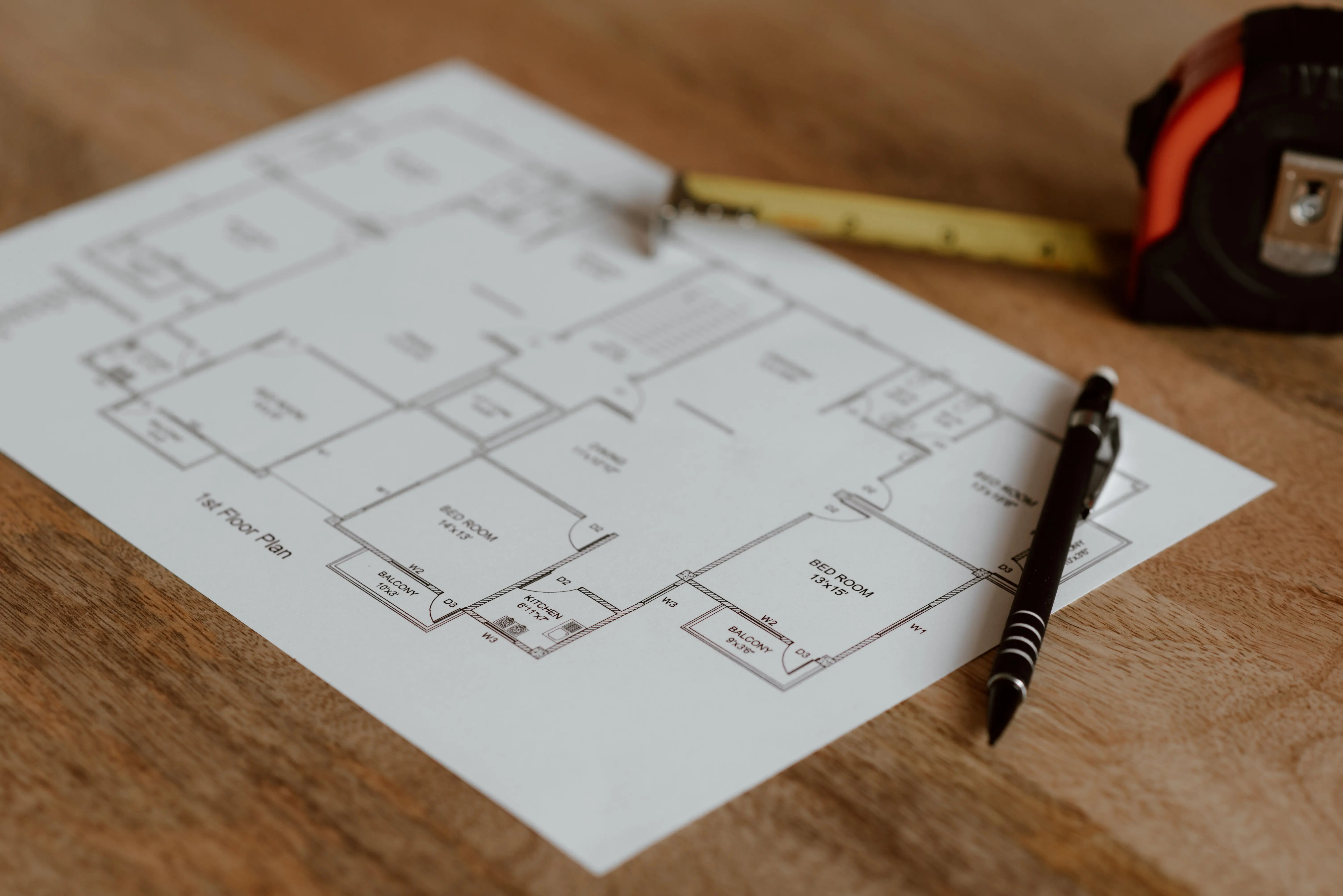 house addition cost Architecture scheme of floor on paper placed on wooden surface near pen and ruler in room during renovation work in building