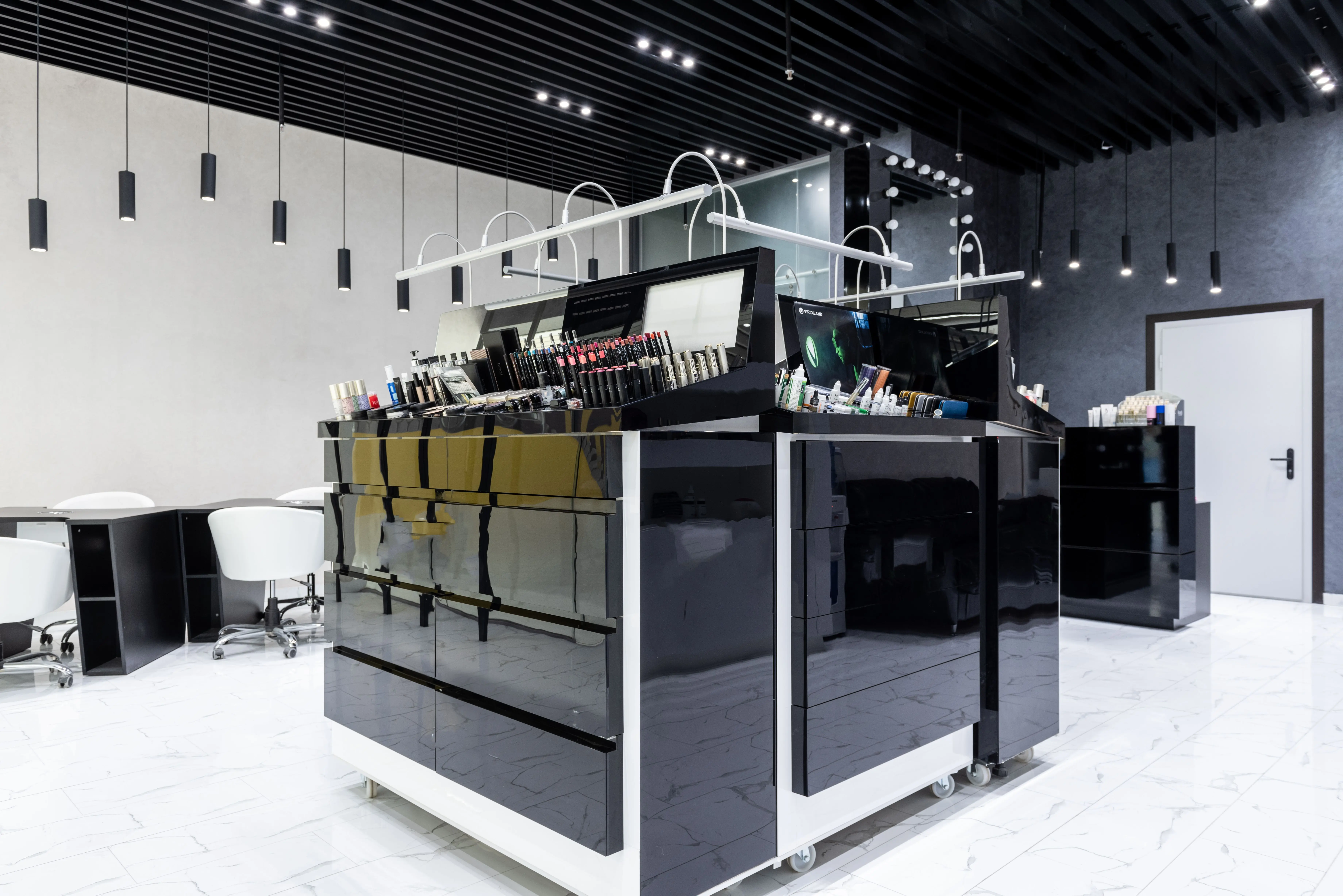 cherry wood cabinets Sleek makeup store interior featuring black glossy cabinets, chairs, and ample lighting.