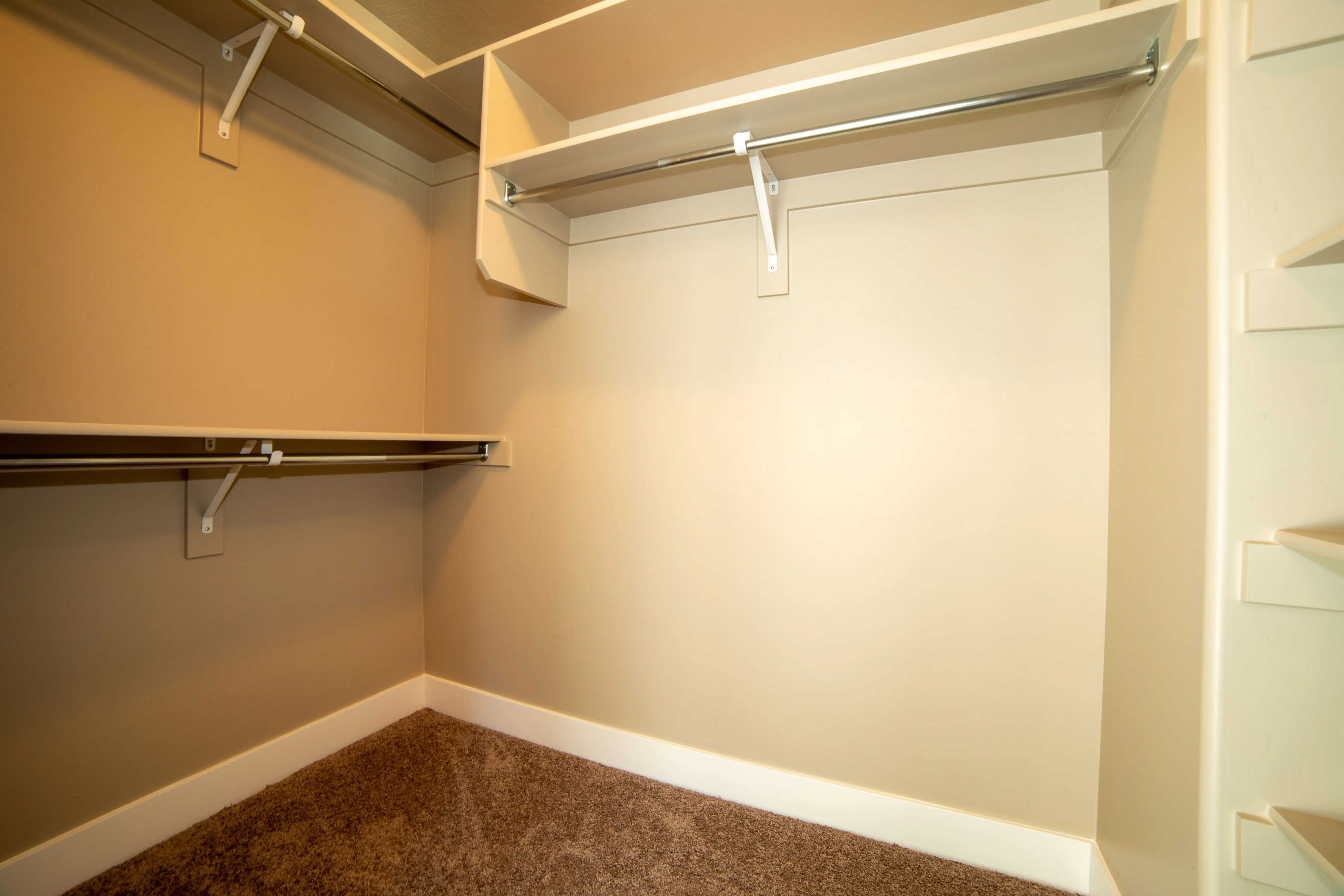 heavy duty closet rod Modern walk-in closet with ample storage and neutral tones.