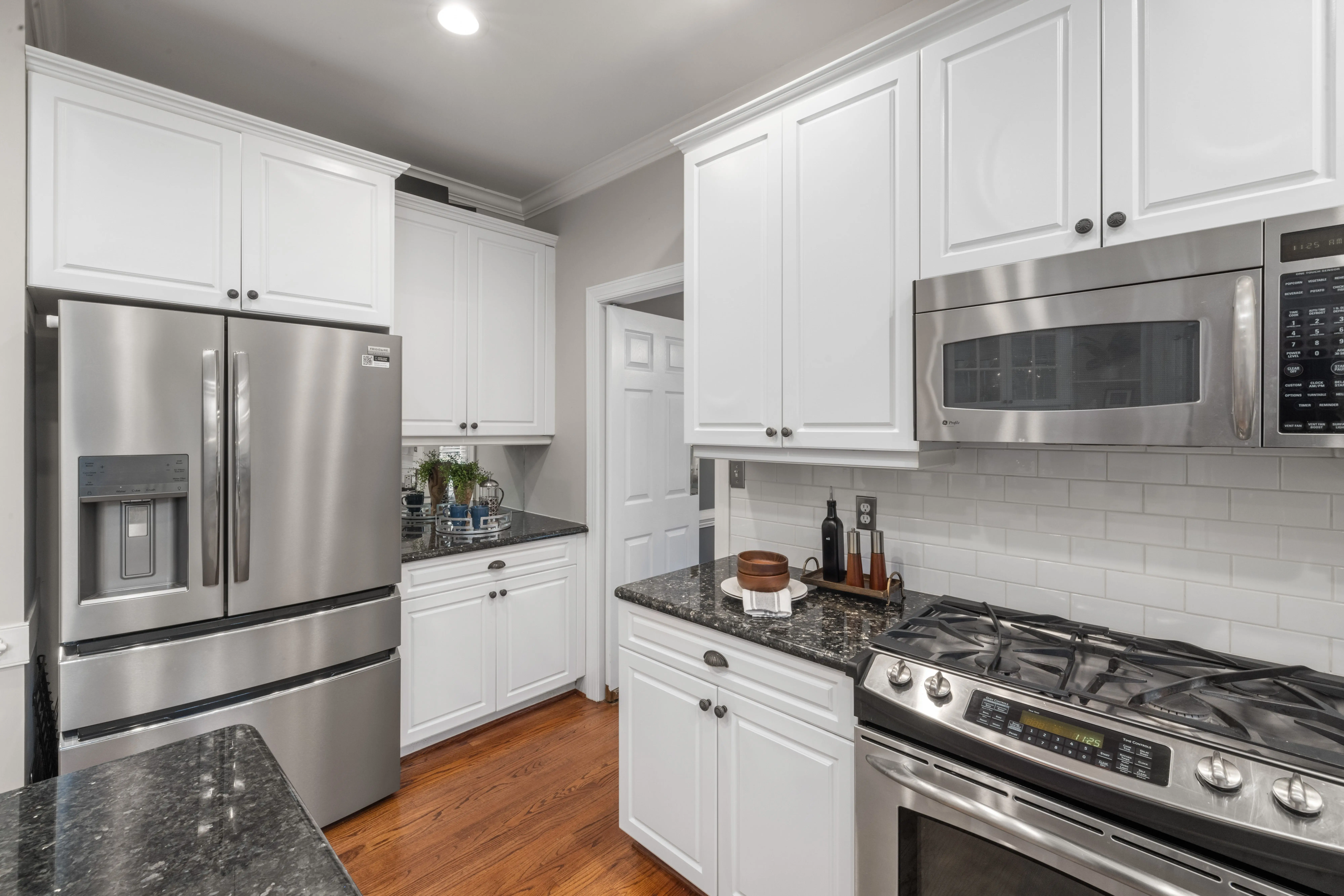 modern kitchen backsplash Contemporary kitchen featuring stainless steel appliances and white cabinetry for a clean, modern look.