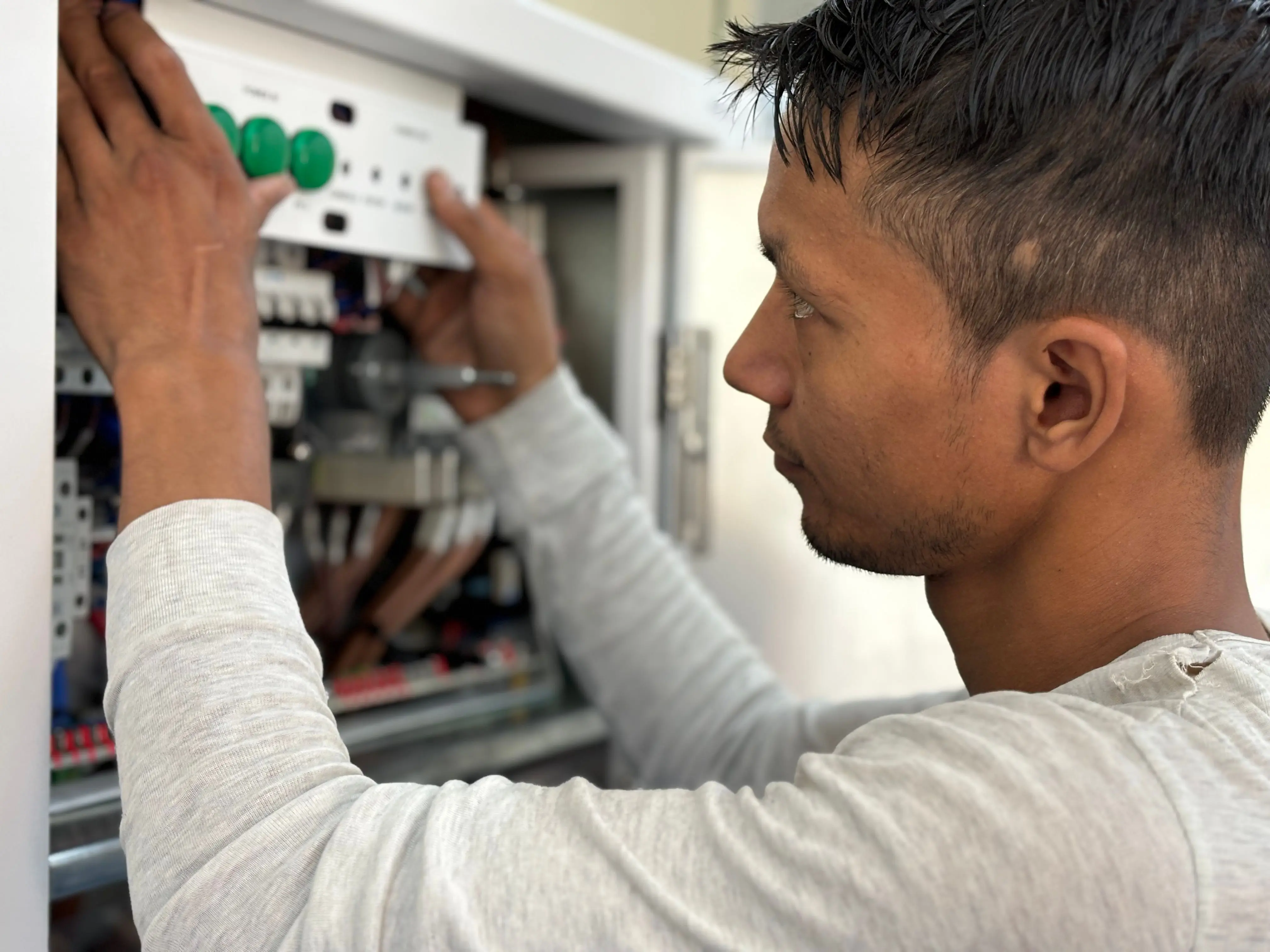 wiring diagram for single light switch Focused electrician adjusting circuit breaker panel. Technology and skill in action.