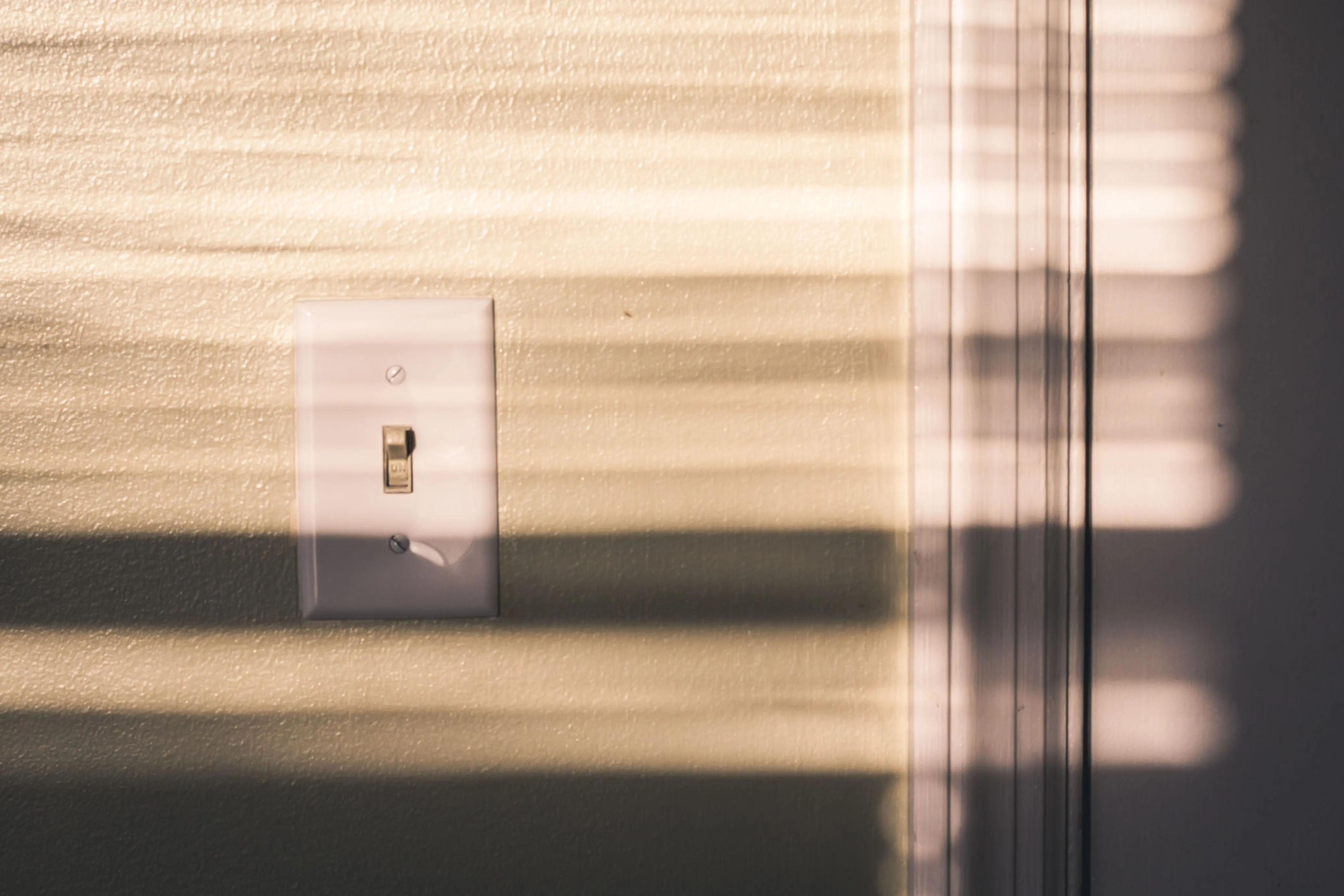 wiring diagram for single light switch A light switch on a wall with dramatic shadows from the blinds in warm indoor lighting.