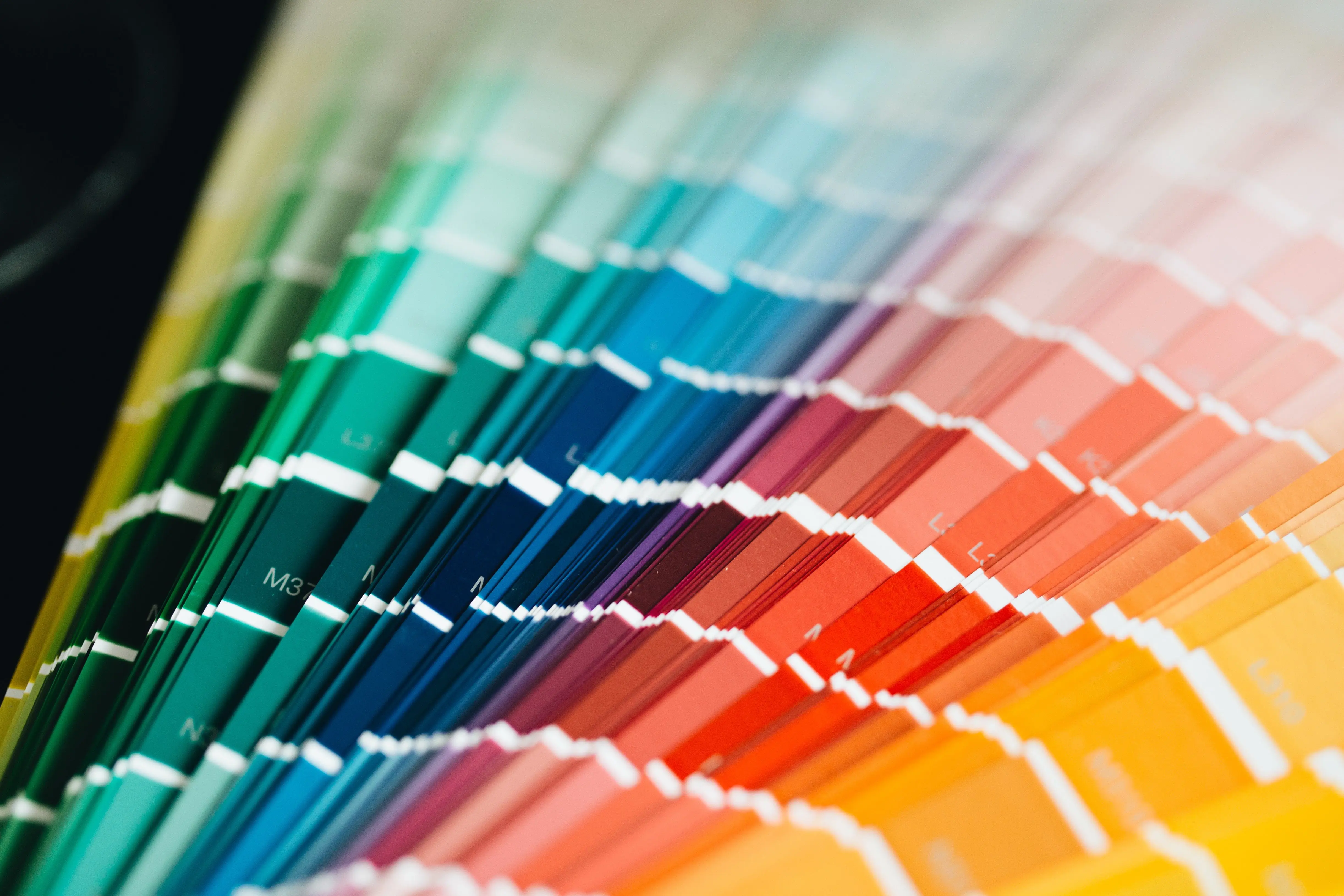 green wall paint Close-up of a vibrant color palette with a rainbow spectrum of hues, perfect for design inspiration.