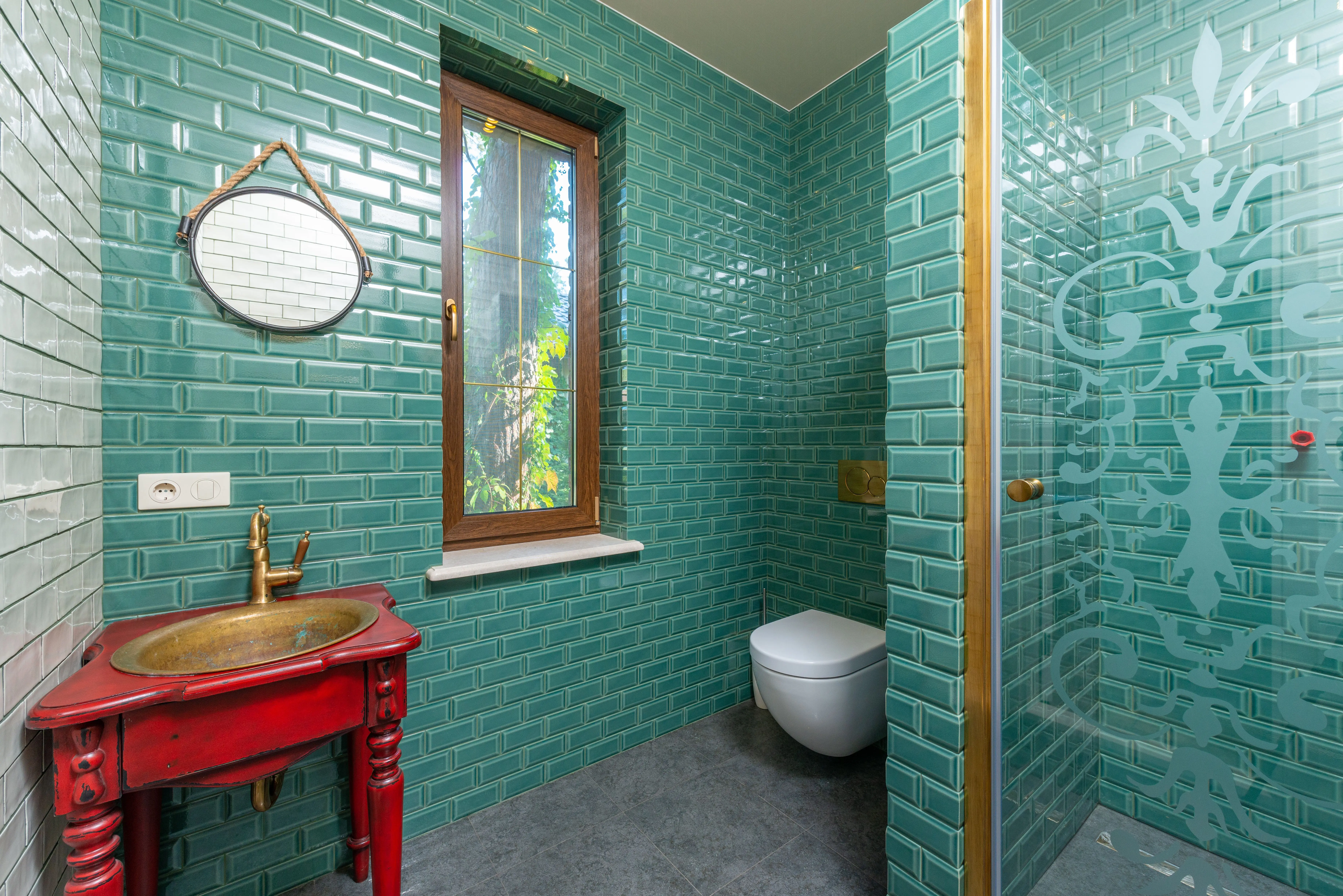 green shower tile Modern bathroom with green tiled walls, gold fixtures, and elegant decor.