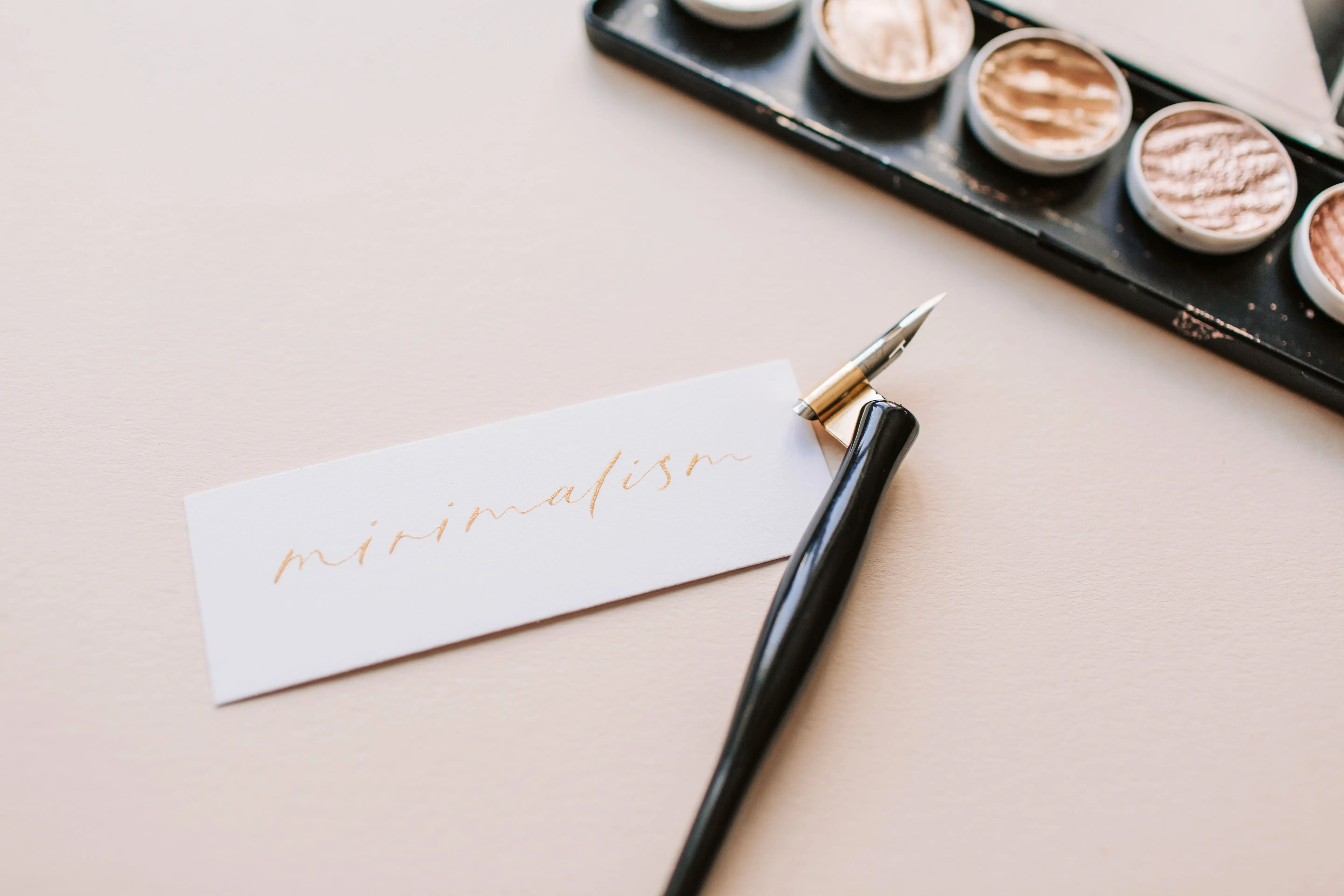 ink remover Beautiful minimalist calligraphy spelling 'minimalism' with a stylish pen on neutral paper.