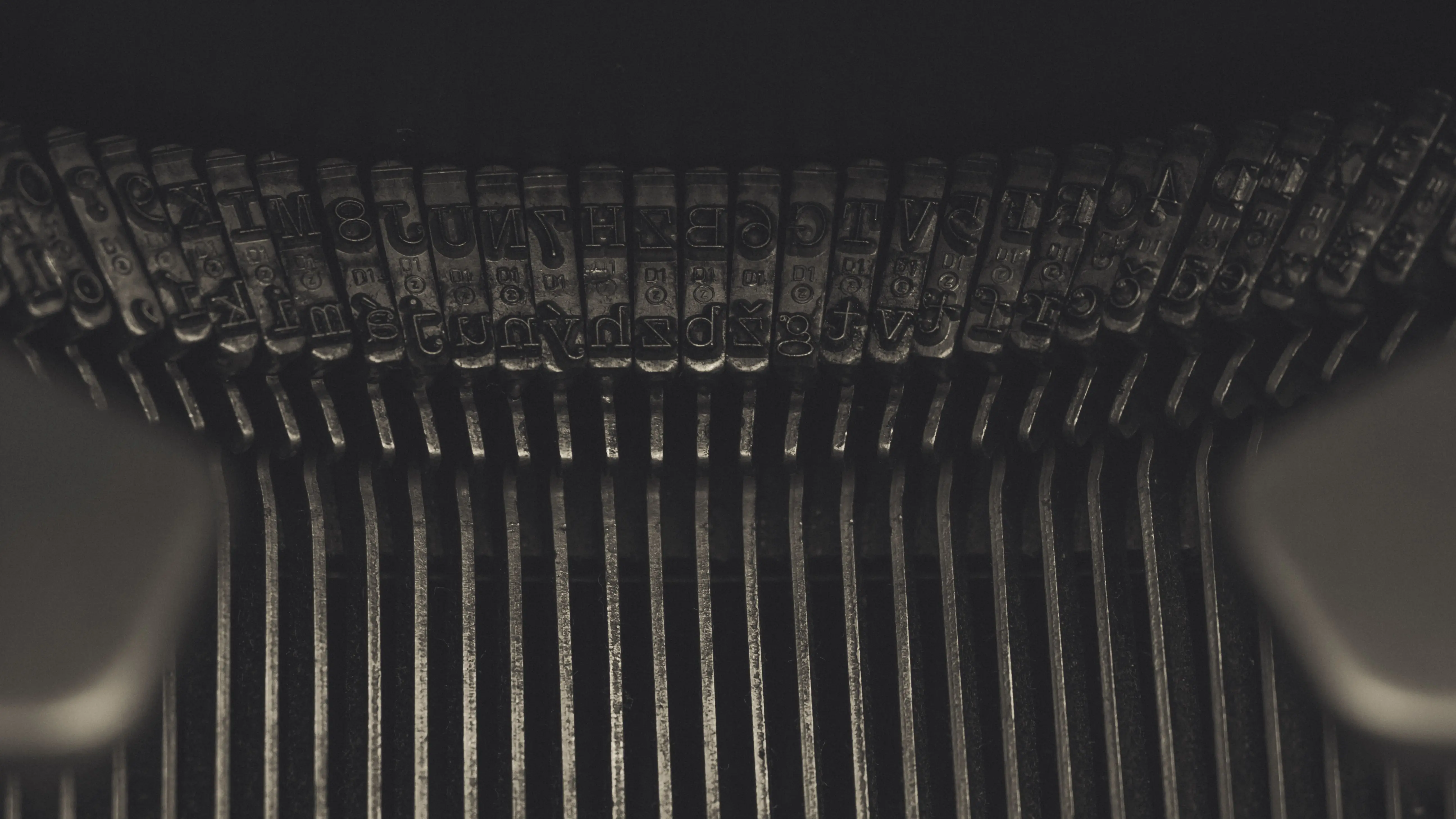 ink remover Detailed view of metallic typebars on an old typewriter highlighting its mechanical complexity.