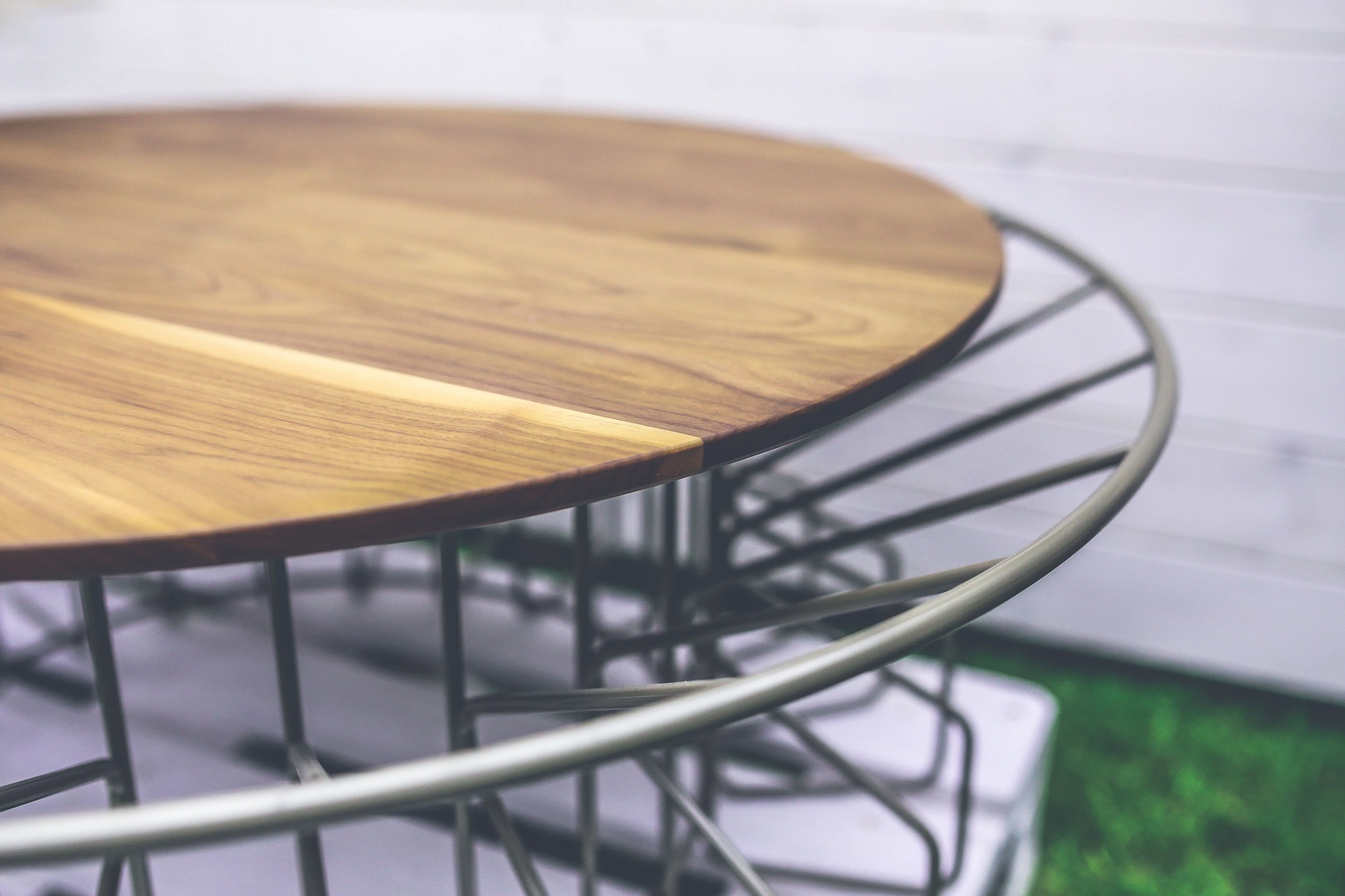 industrial furniture Stylish round wooden table with metal frame, perfect for modern outdoor spaces.