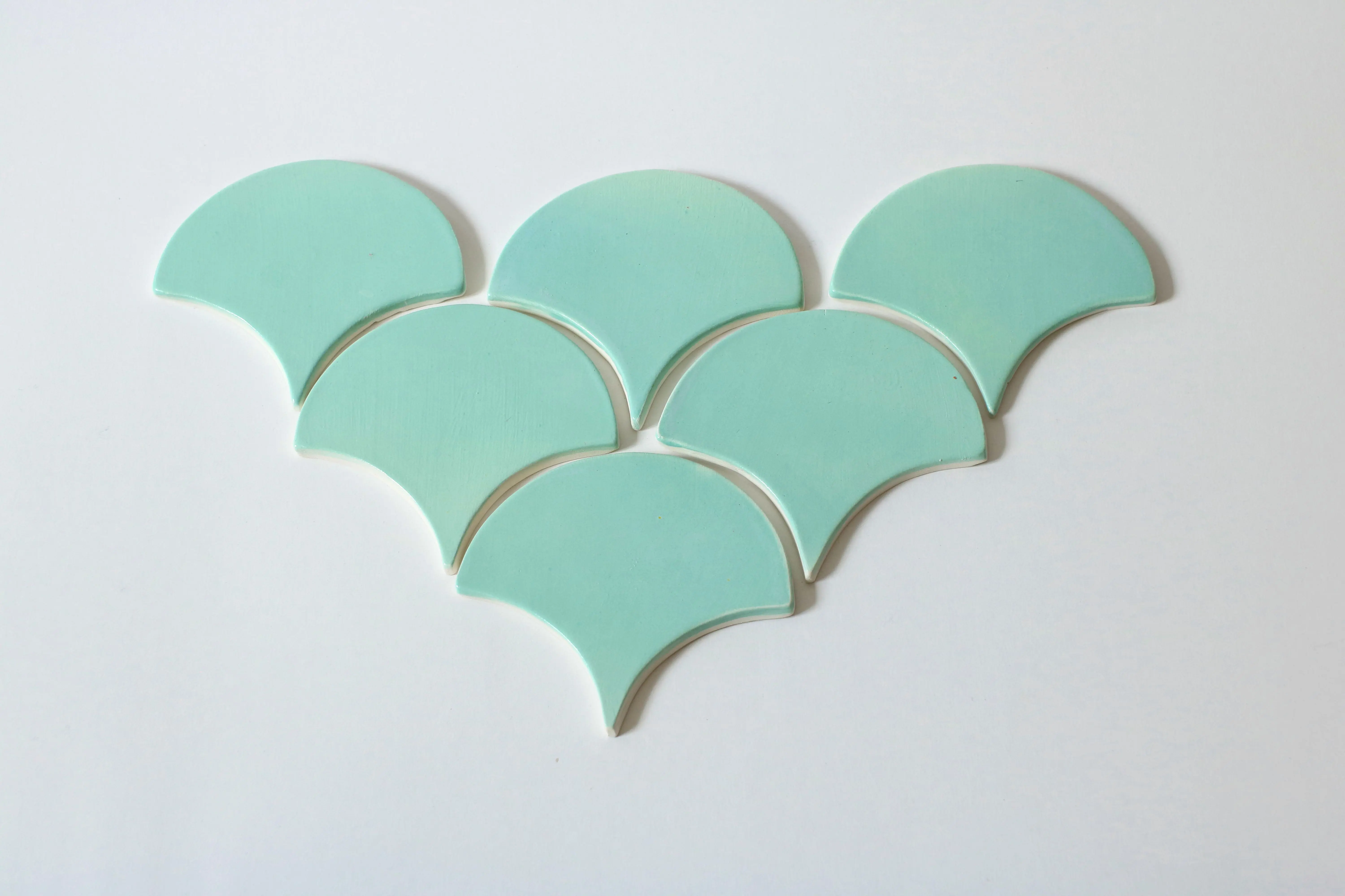 green tile backsplash Creative arrangement of mint green pastel shapes forming a unique abstract pattern.