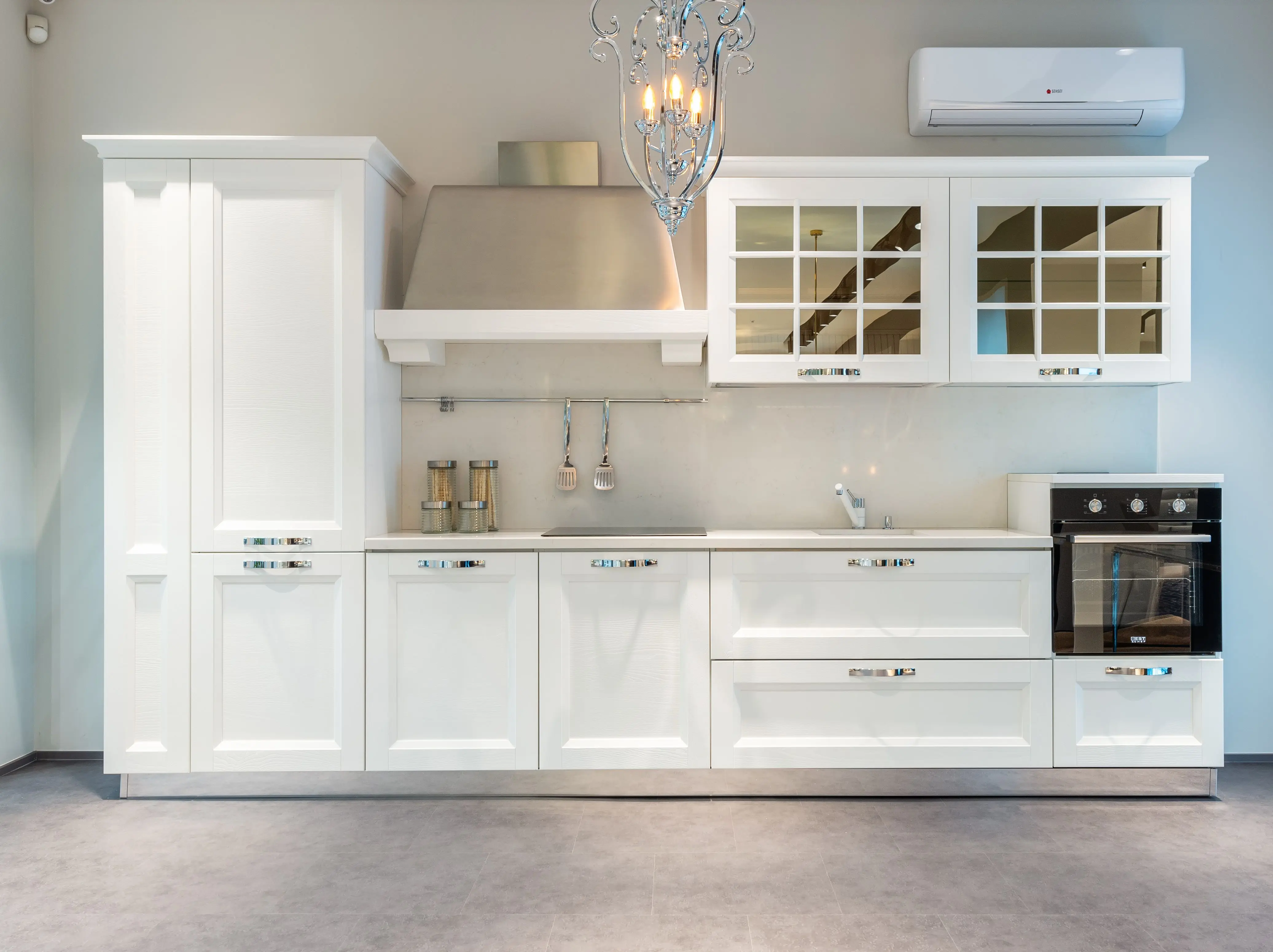 white shaker kitchen cabinets Interior of modern furnished kitchen with elegant white cabinets and contemporary appliances in spacious apartment