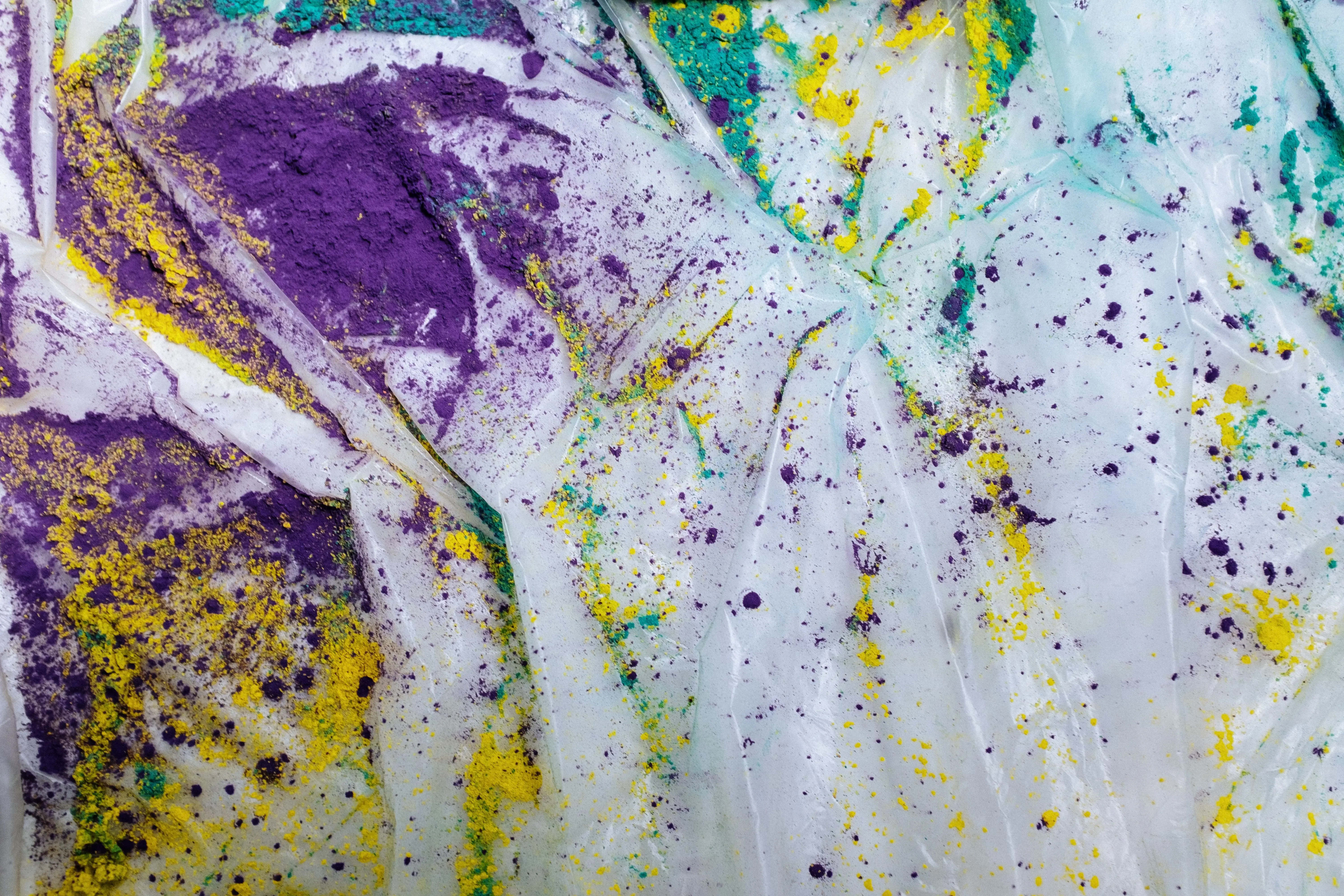 how to get blood stains out of jeans Dynamic abstract image featuring vibrant colored powders on white fabric, showcasing artistic creativity.