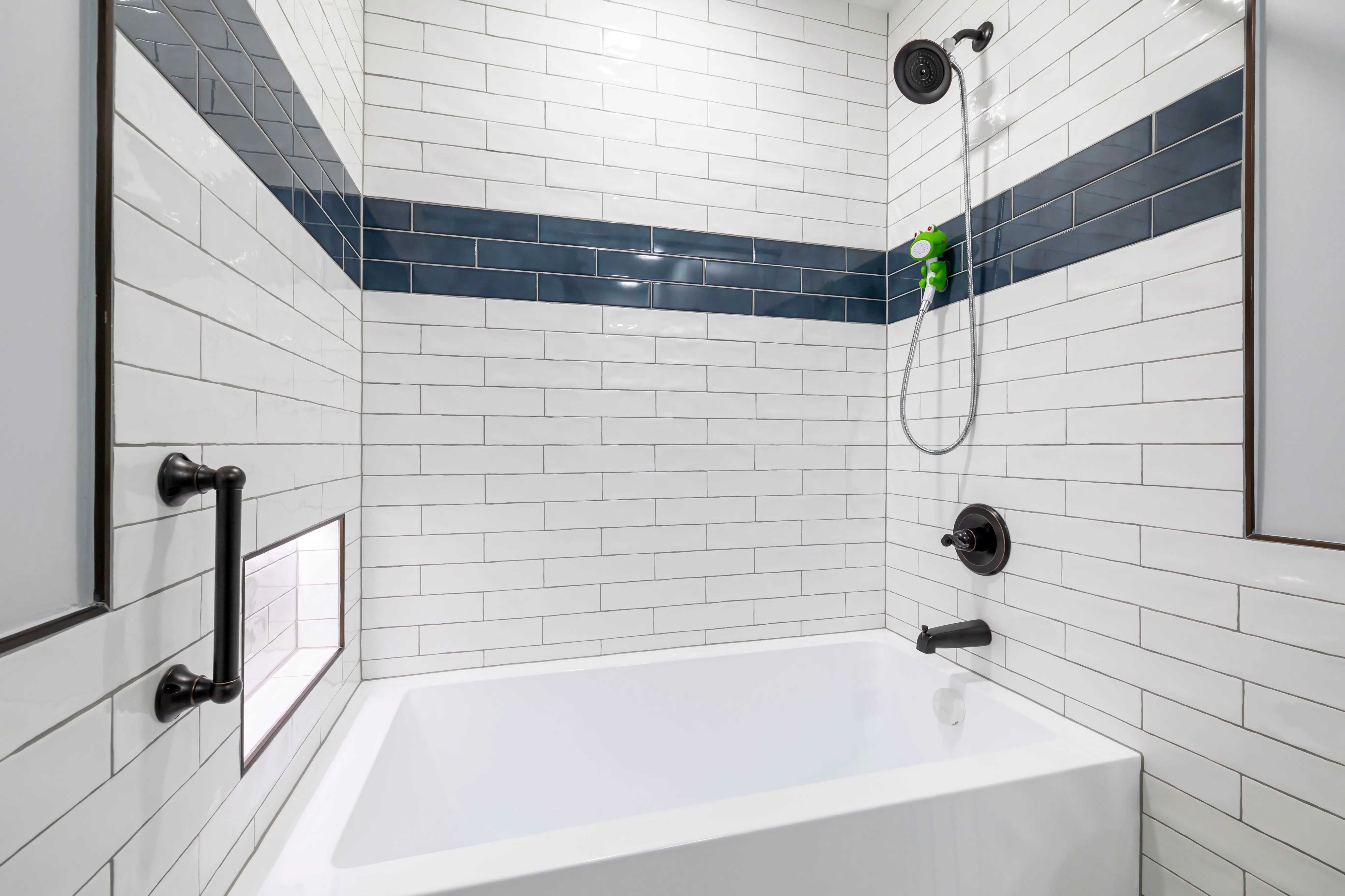 tub inside shower Sleek, minimalist bathroom with white and blue tiles and contemporary fixtures.