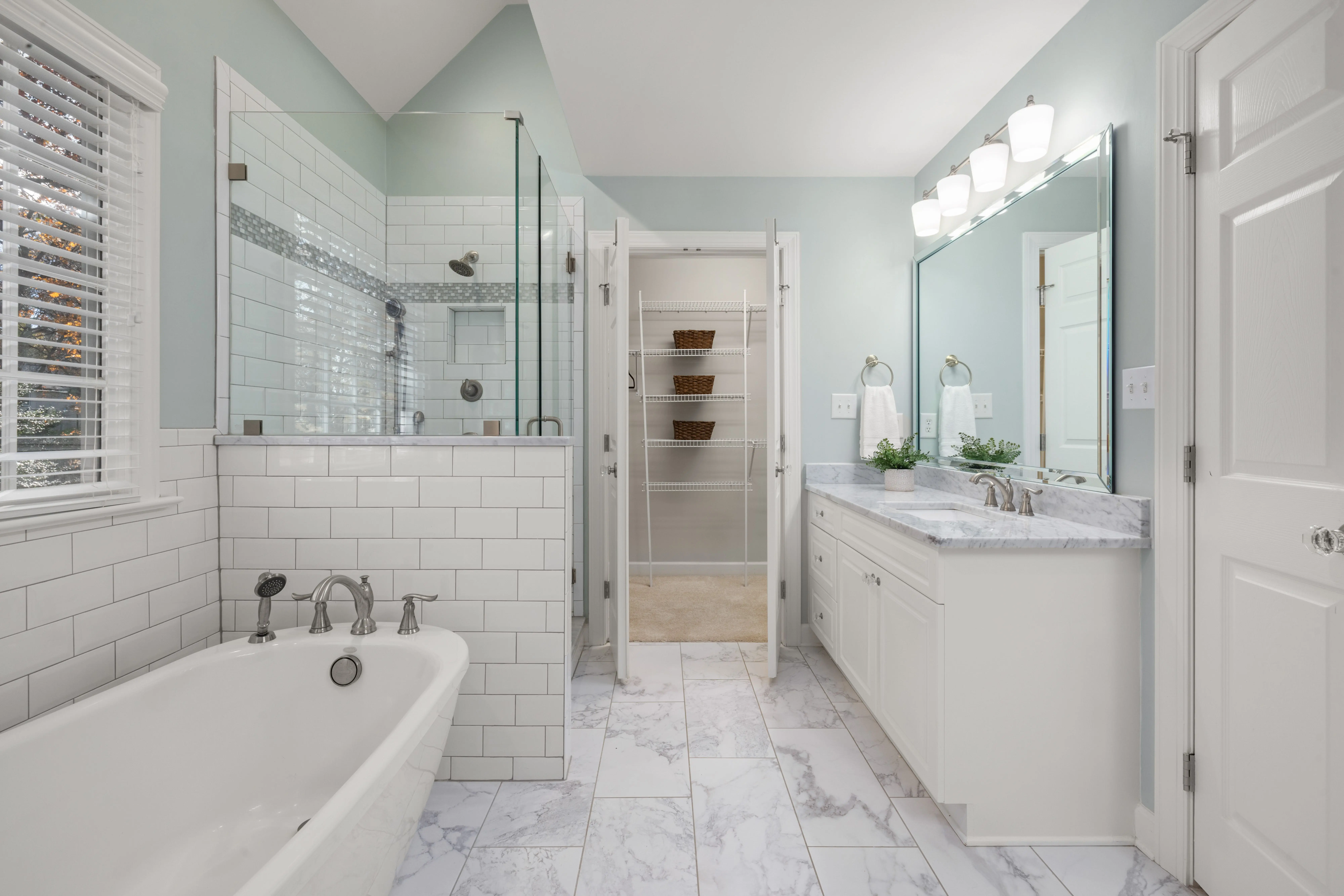 shower to bathtub conversion Elegant bathroom with white marble, glass shower, and bright lighting. Perfect for luxury home decor inspiration.