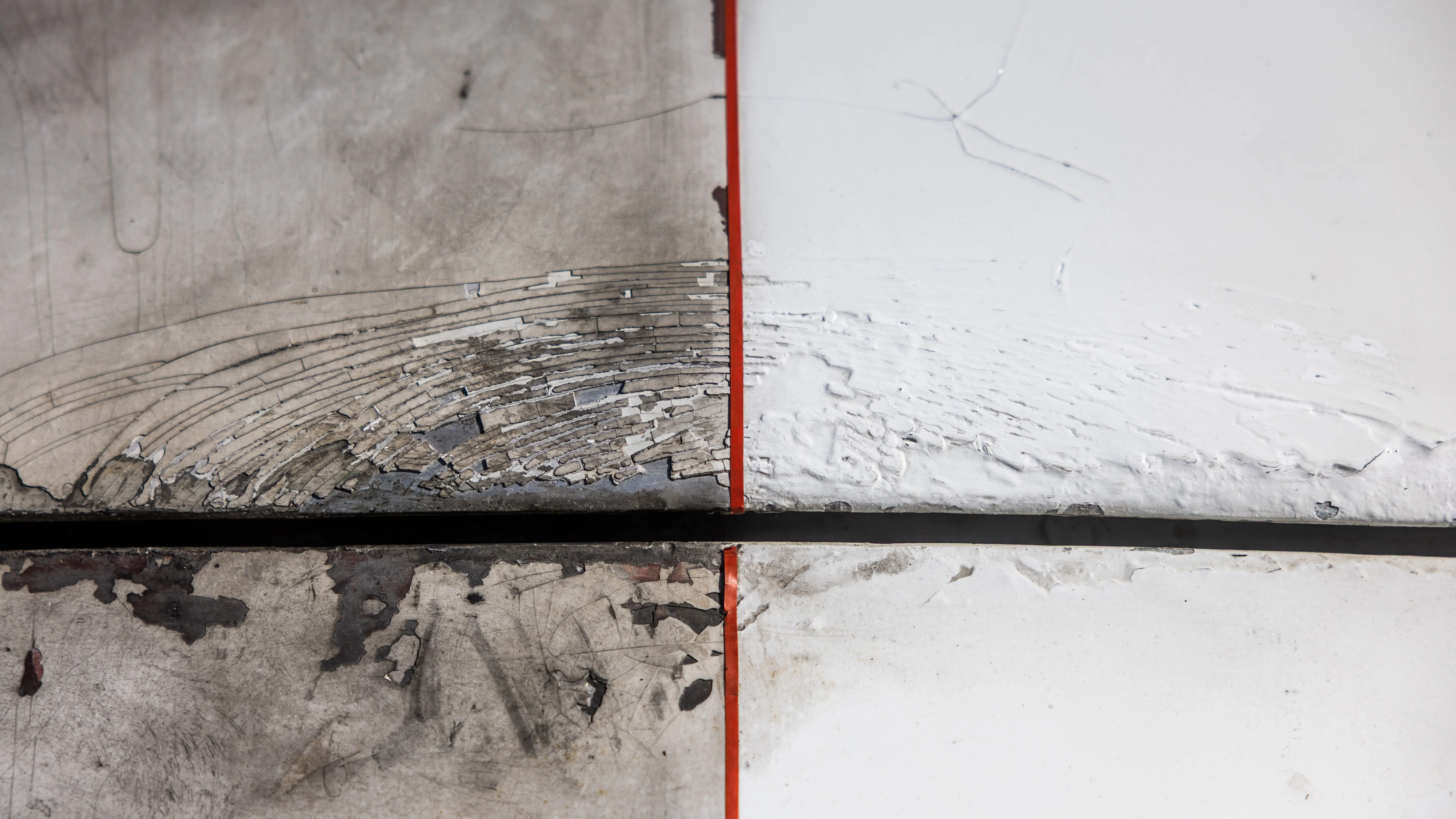 how to fix paint chips on car Abstract image of a weathered, peeling surface bisected by a thin red line.