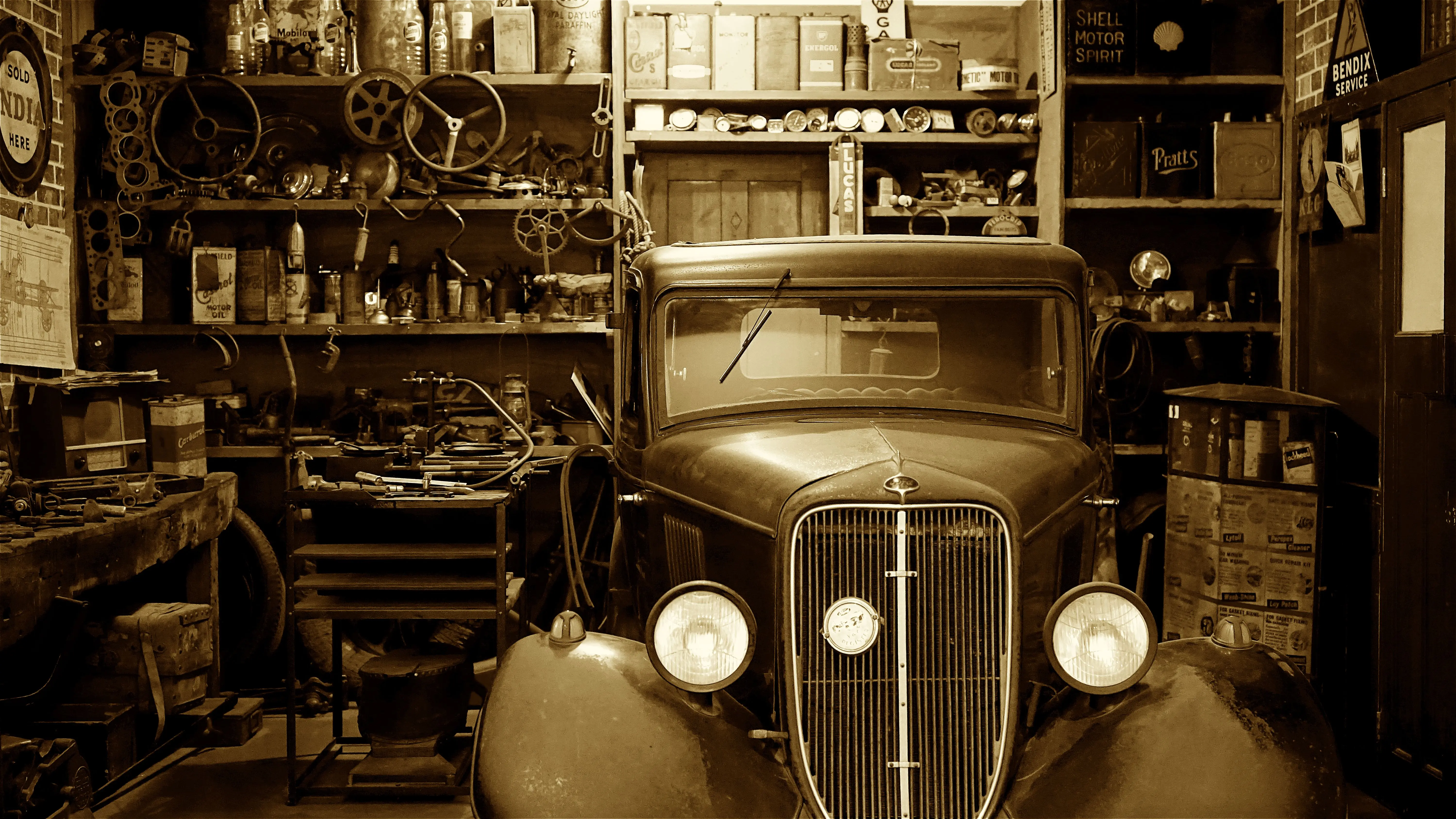 how to fix paint chips on car A vintage car surrounded by antique tools and parts in a nostalgic workshop.