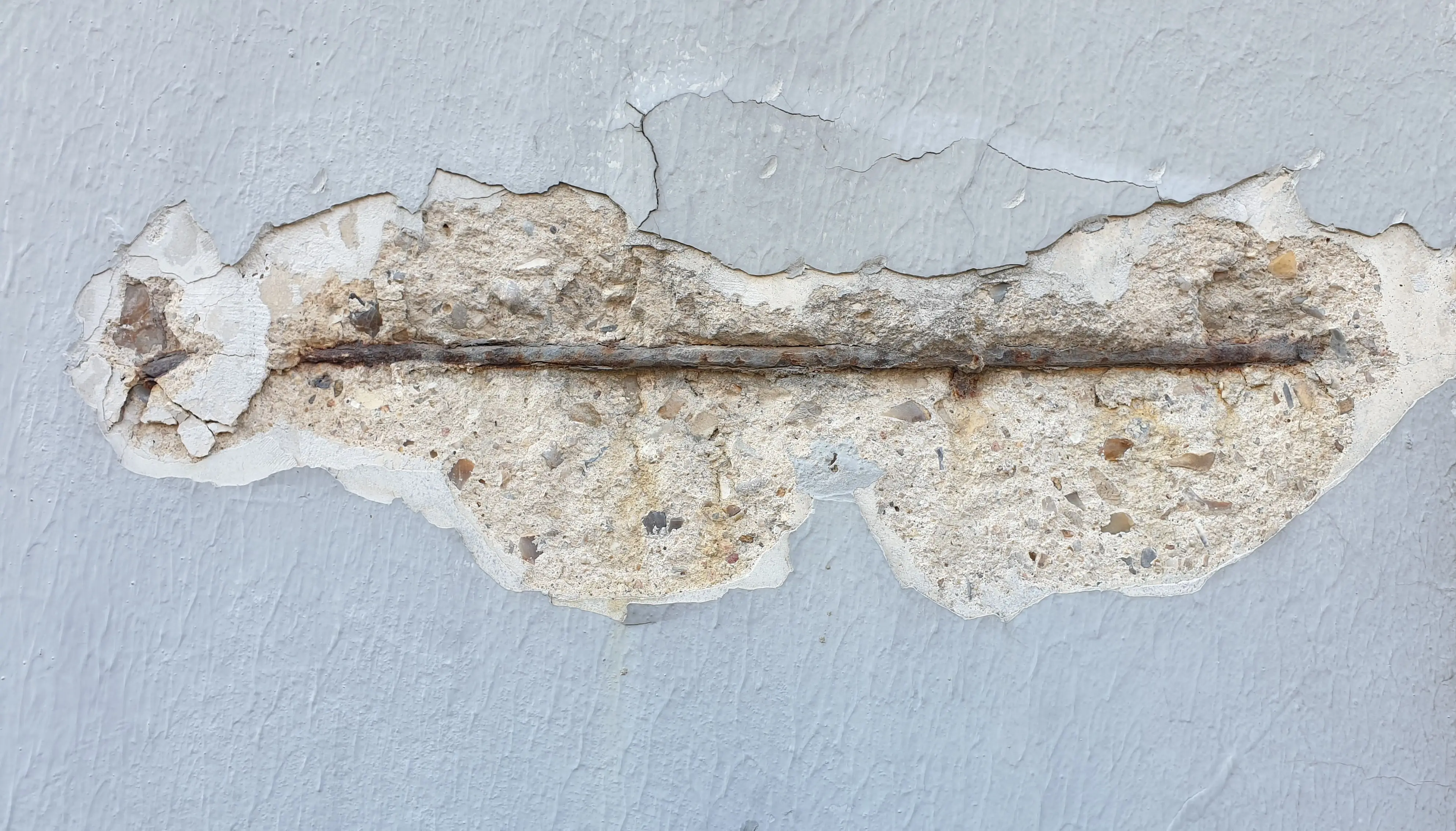 toilet flapper not sealing Detailed close-up of a wall with peeling paint and exposed metal bar.