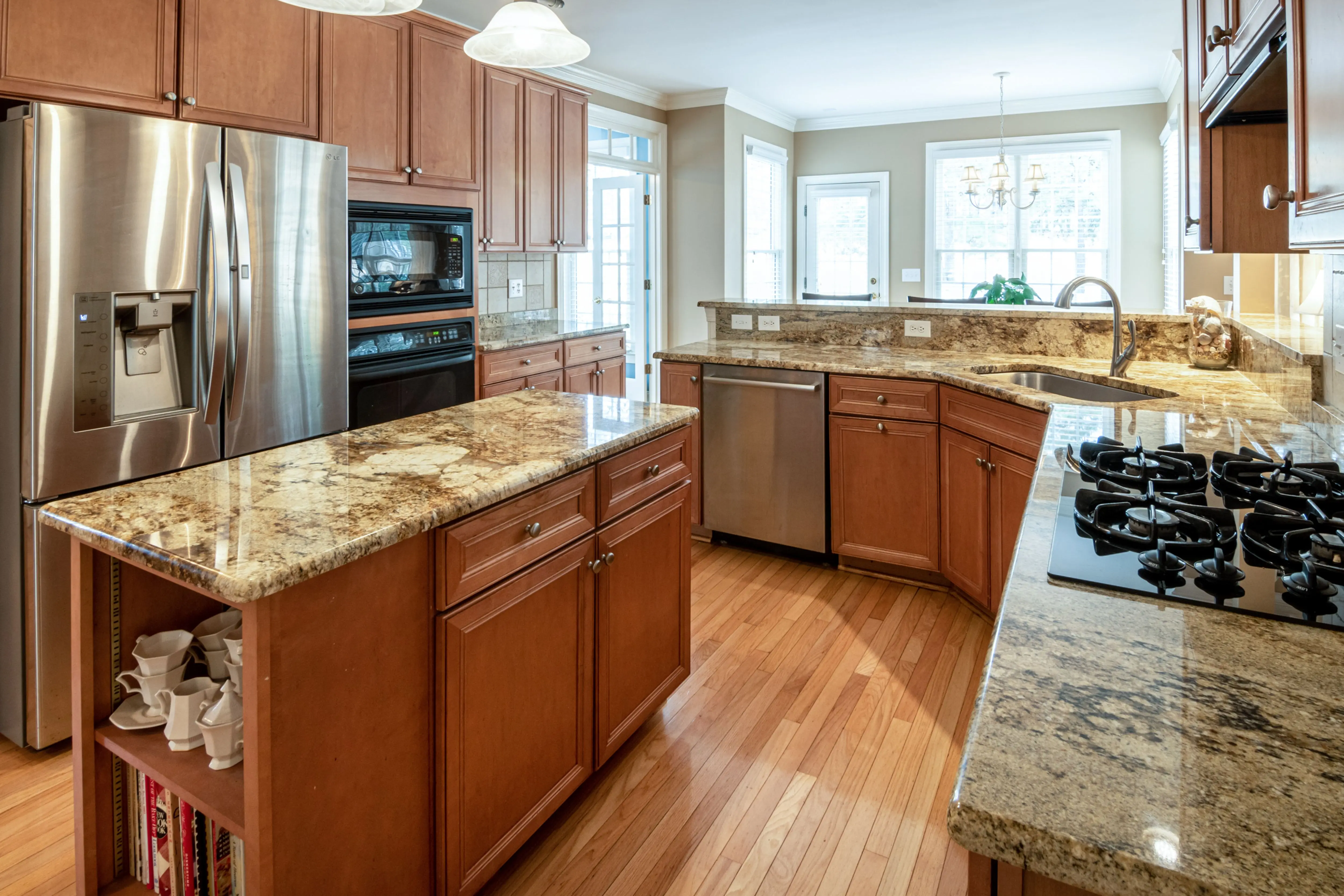 green granite A luxurious kitchen interior featuring granite countertops and modern appliances.