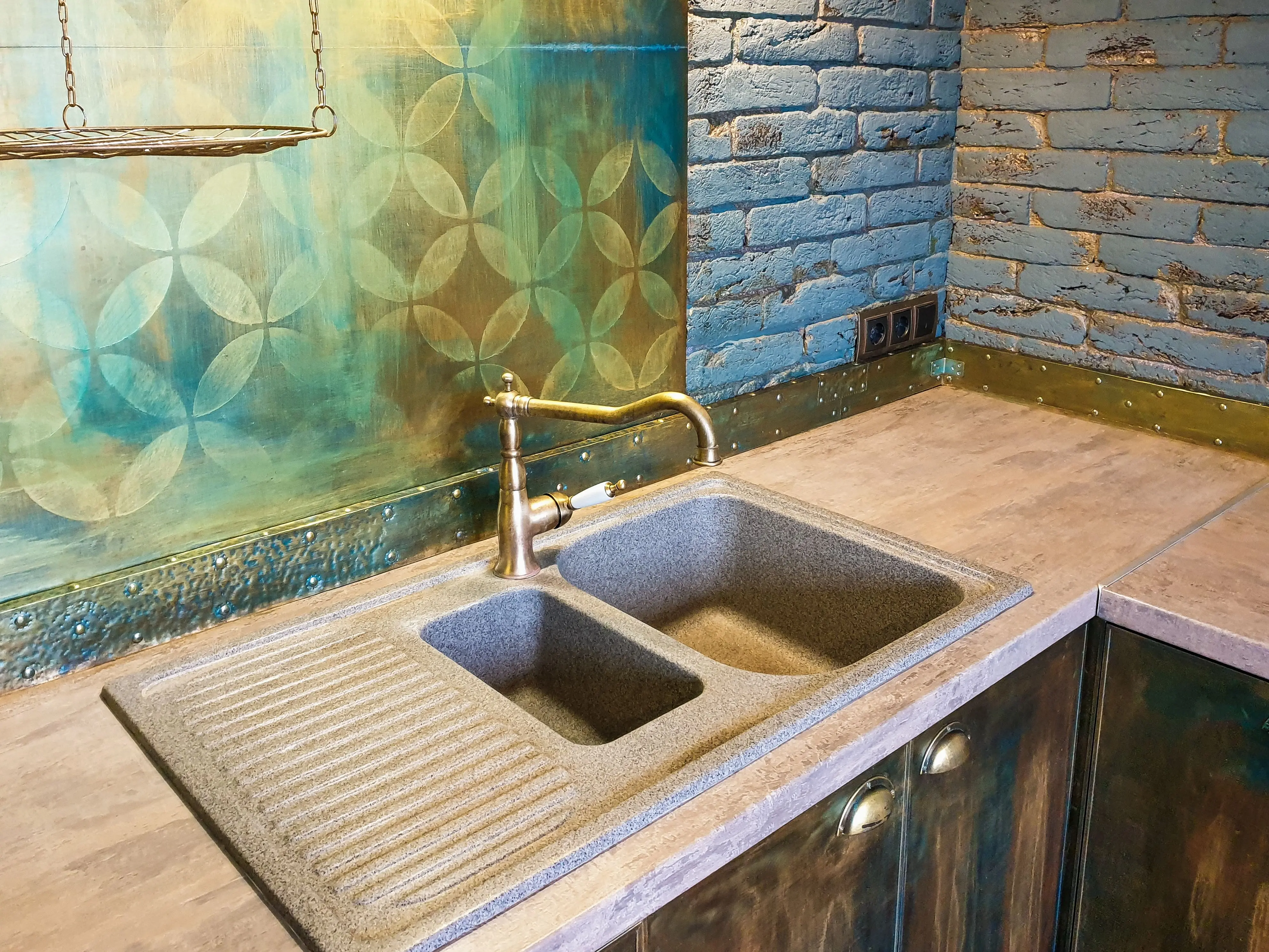 rustic cabinets Cozy kitchen interior featuring a rustic double sink, decorative brick wall, and vibrant backsplash.