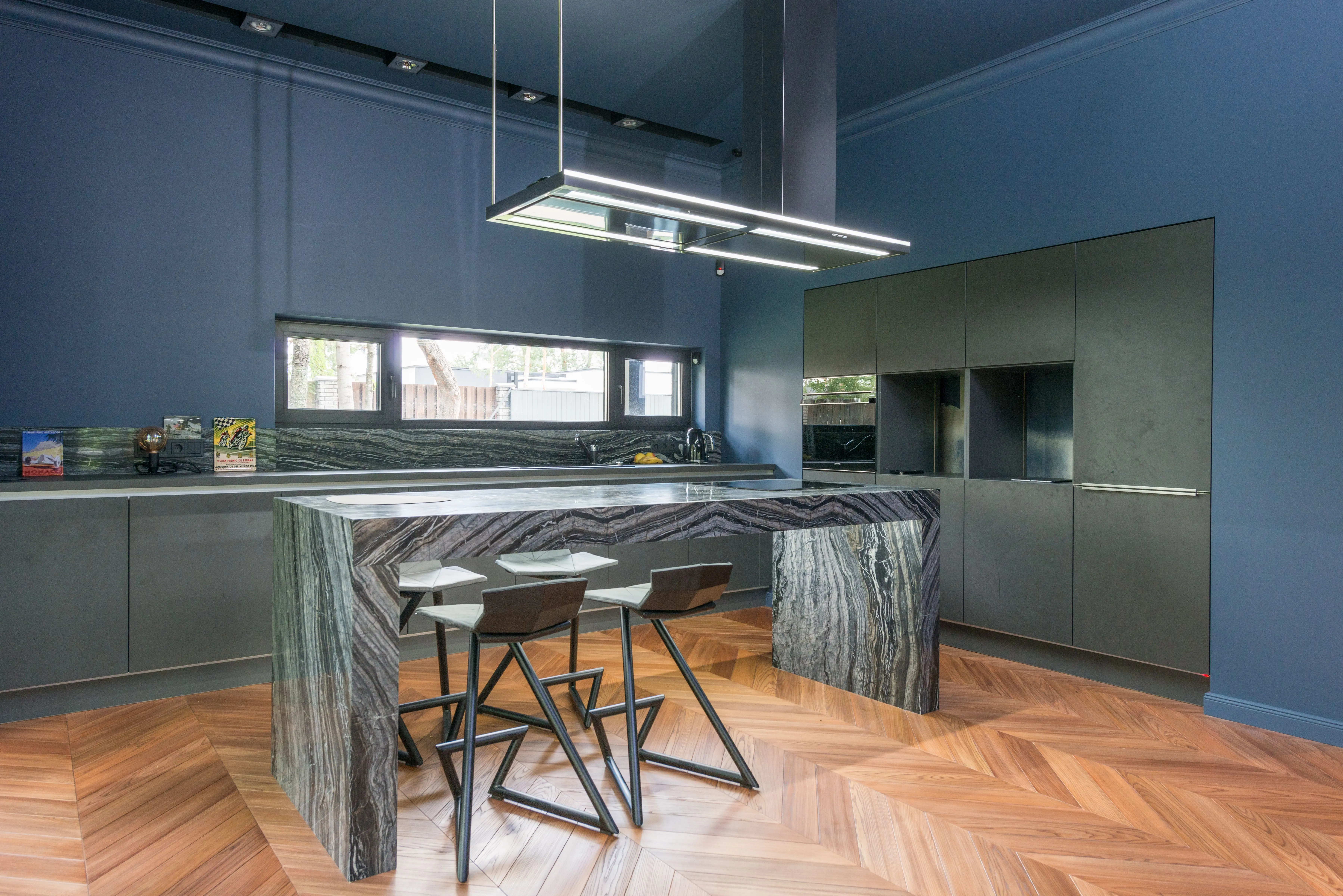 kitchen work table Contemporary blue kitchen featuring a sleek granite island and modern decor.