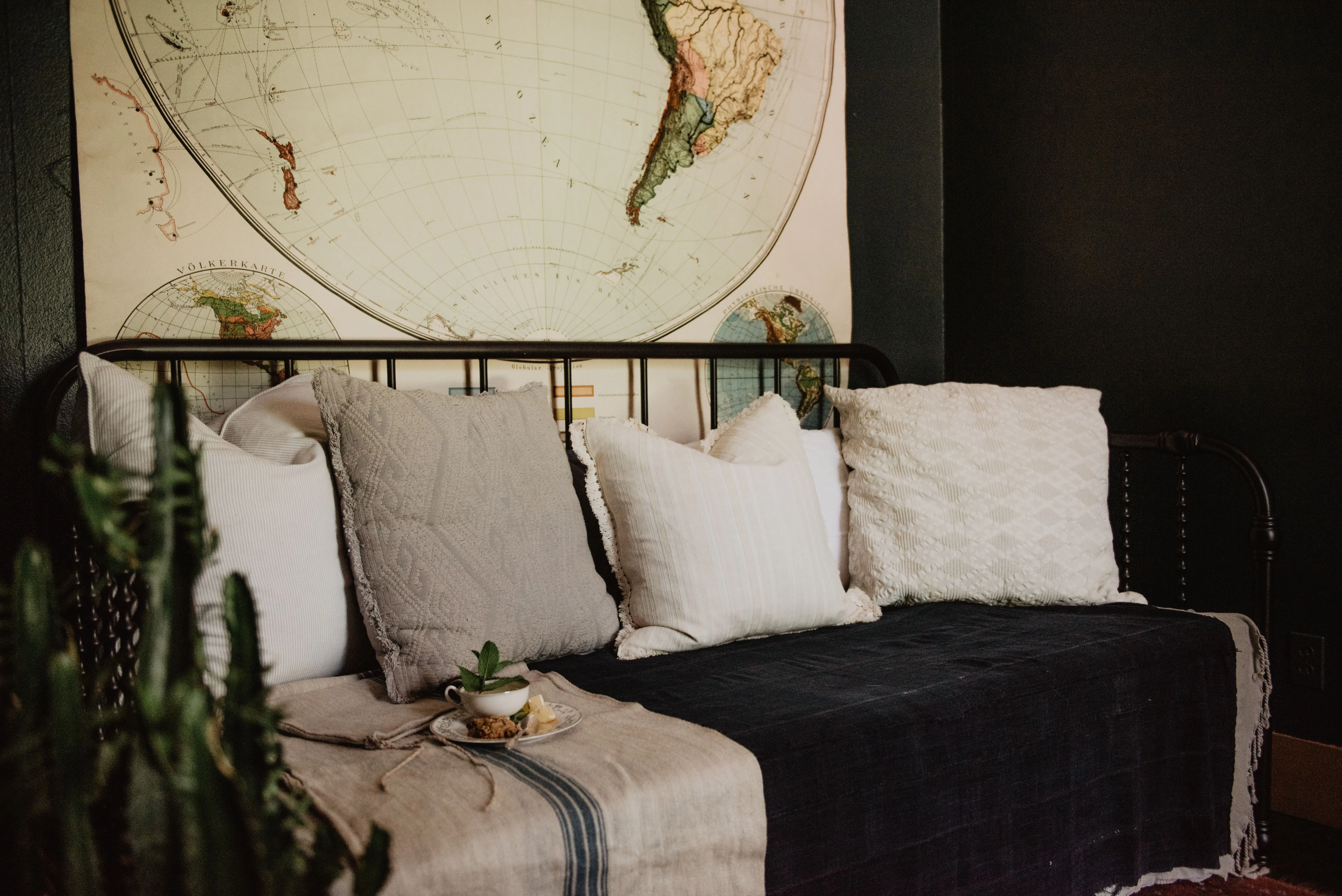 lumbar pillow covers Modern home interior featuring a comfortable sofa with pillows and a vintage map backdrop for stylish relaxation.