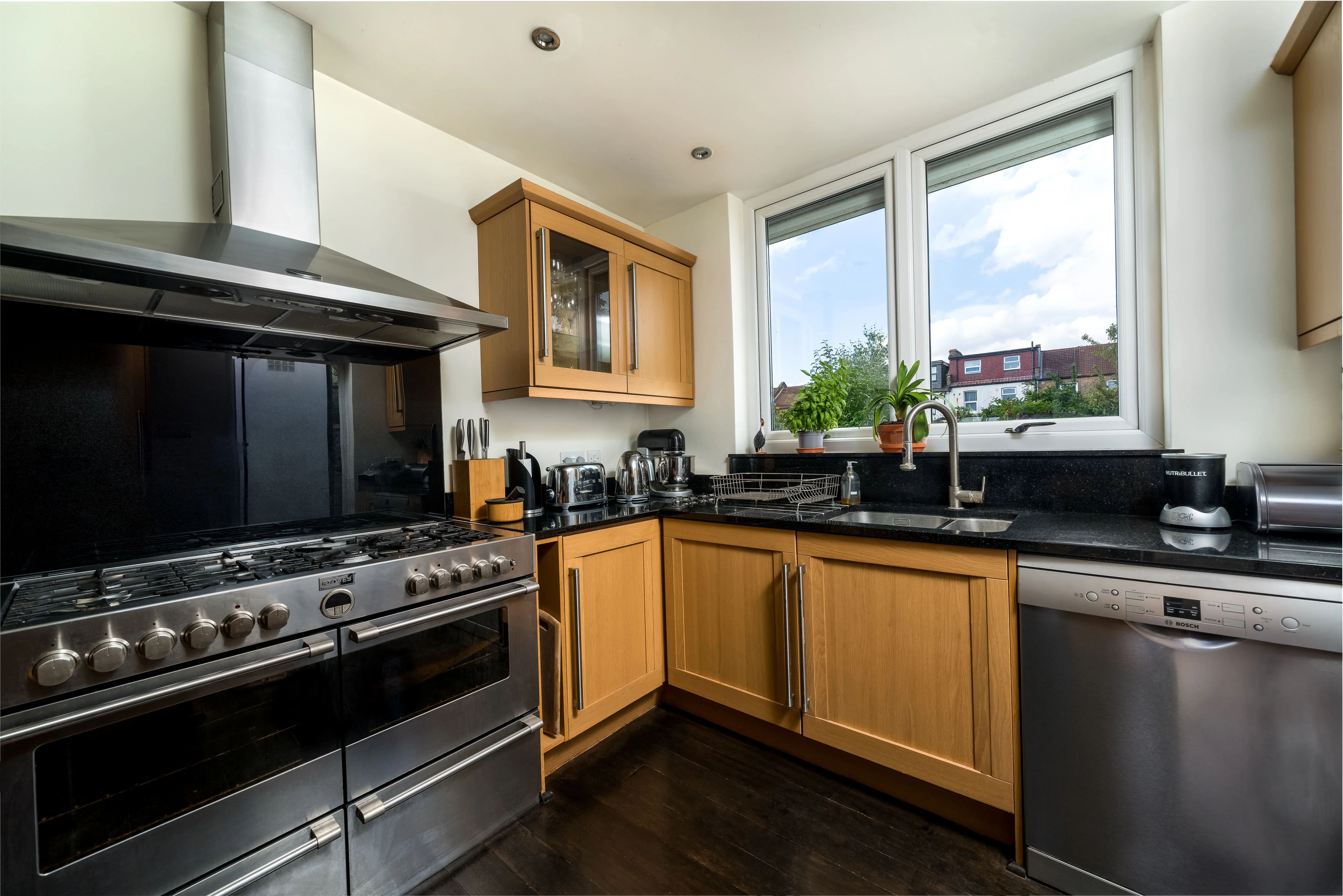 luxury home renovations A stylish modern kitchen featuring wooden cabinets and stainless steel appliances.