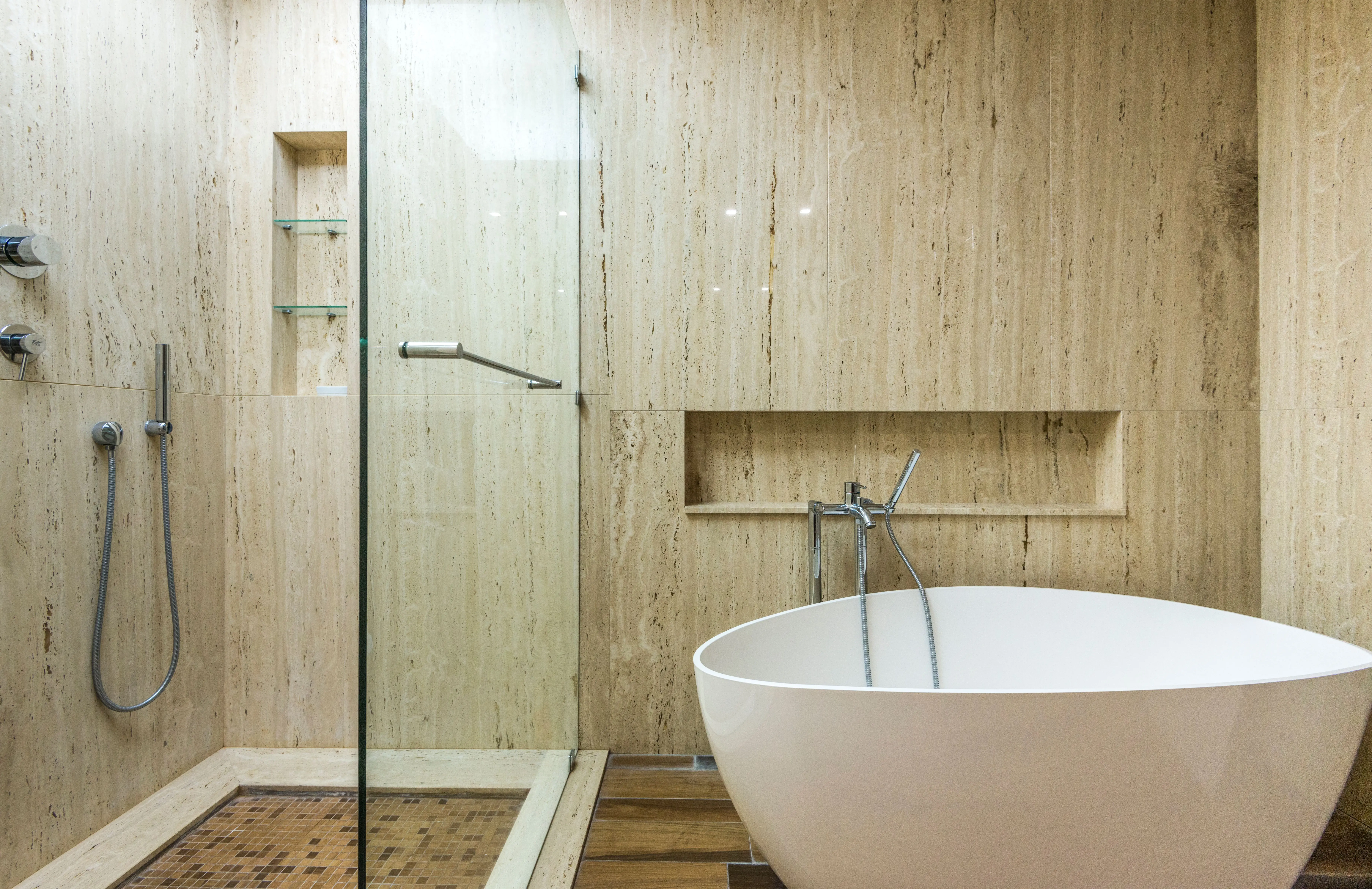 shower floors Sleek minimalist bathroom featuring a freestanding bathtub and glass shower with contemporary design.