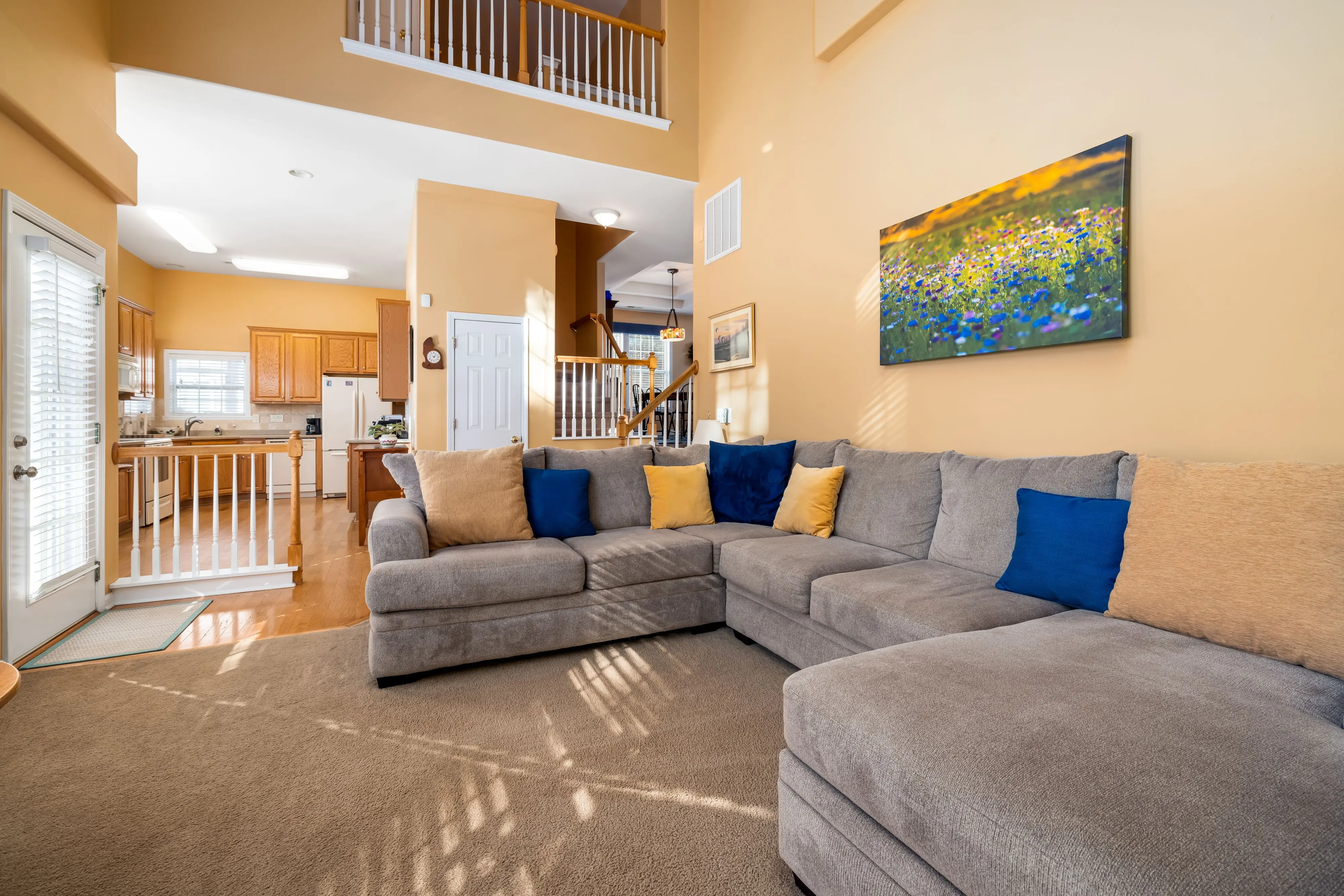 luxury home renovations Bright and spacious living room showcasing a cozy grey sofa and modern interior design.