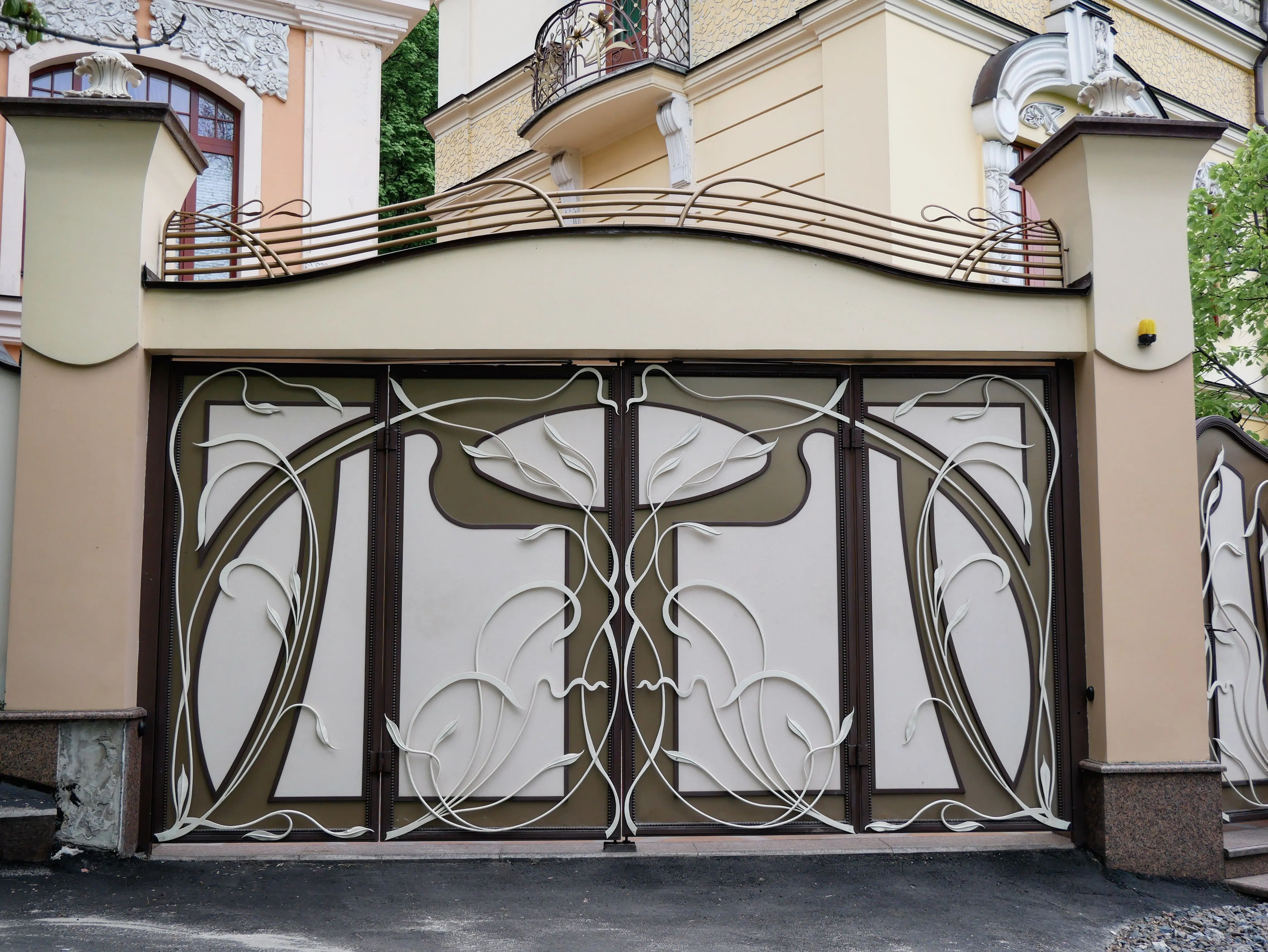 pvc fence gate Elegant Art Nouveau gate with intricate floral design in a city architecture setting.