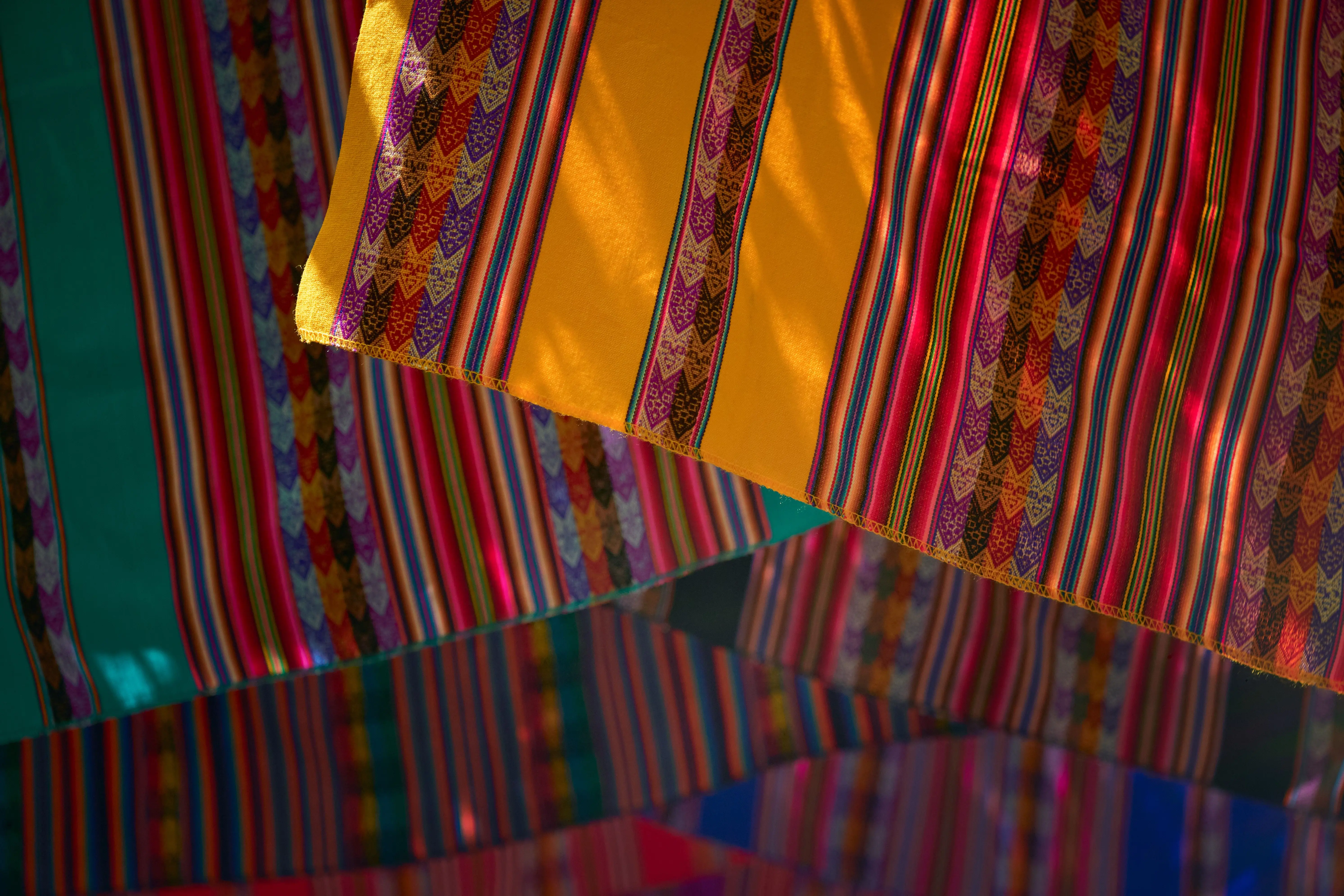 patterned drapes Vibrant traditional fabric with colorful stripes and geometric patterns creating a lively feel.
