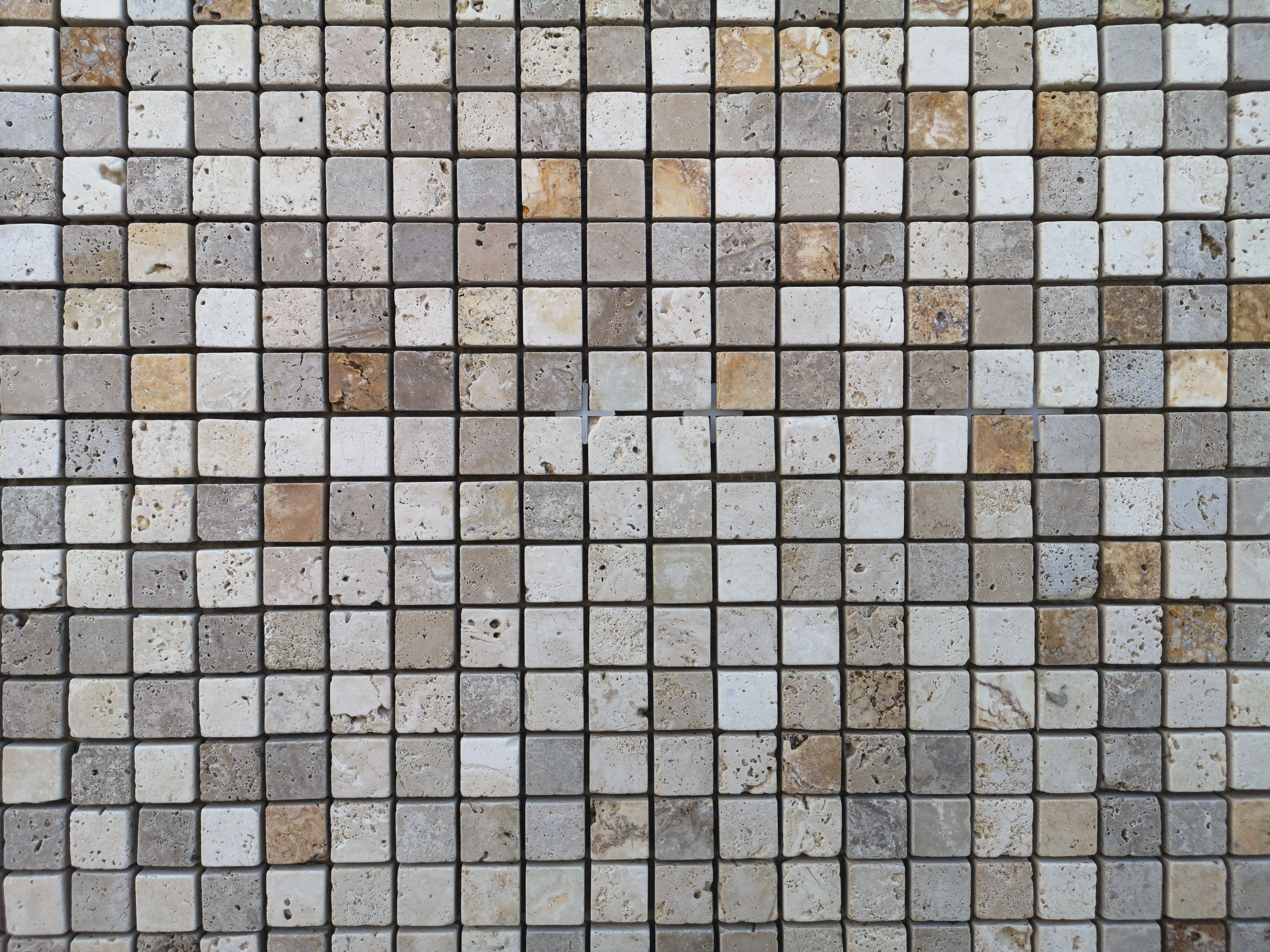 shower floors Detailed view of a geometric mosaic tile wall featuring a neutral color palette.