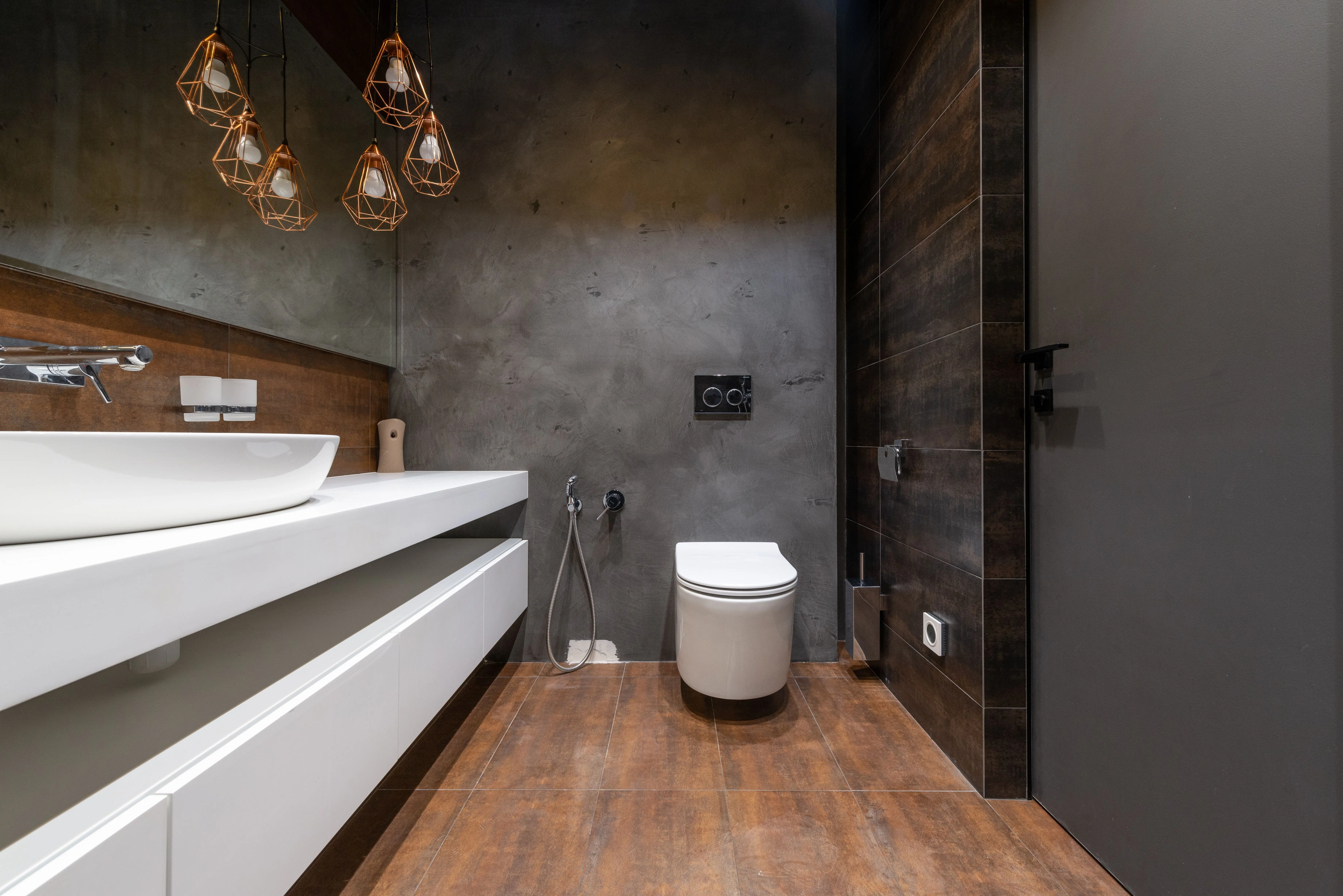 toilet flapper not sealing Sleek modern bathroom featuring a minimalist sink and elegant hanging lights.