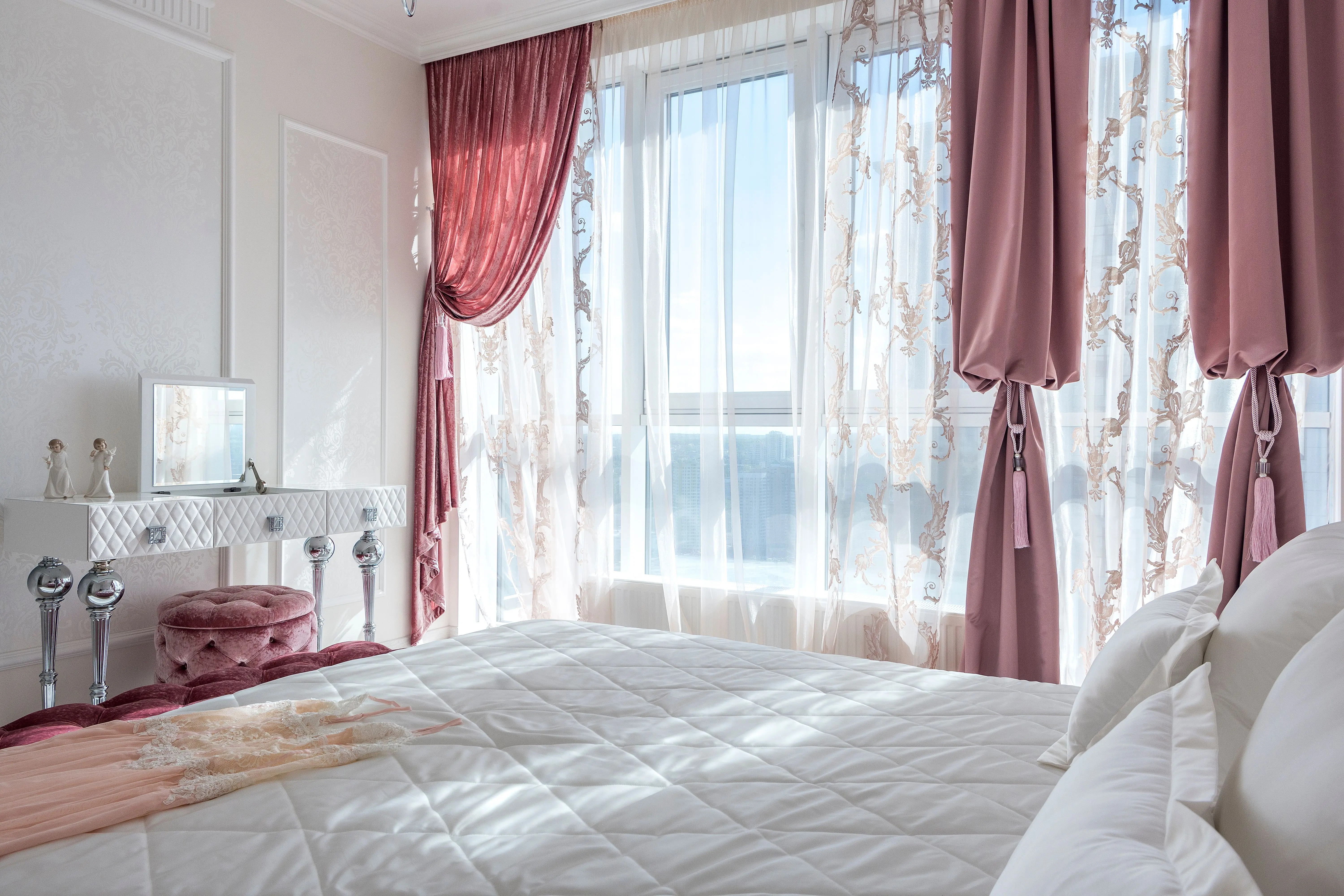 patterned drapes Cozy and elegant white and rosy bedroom with comfortable bed and draped curtains