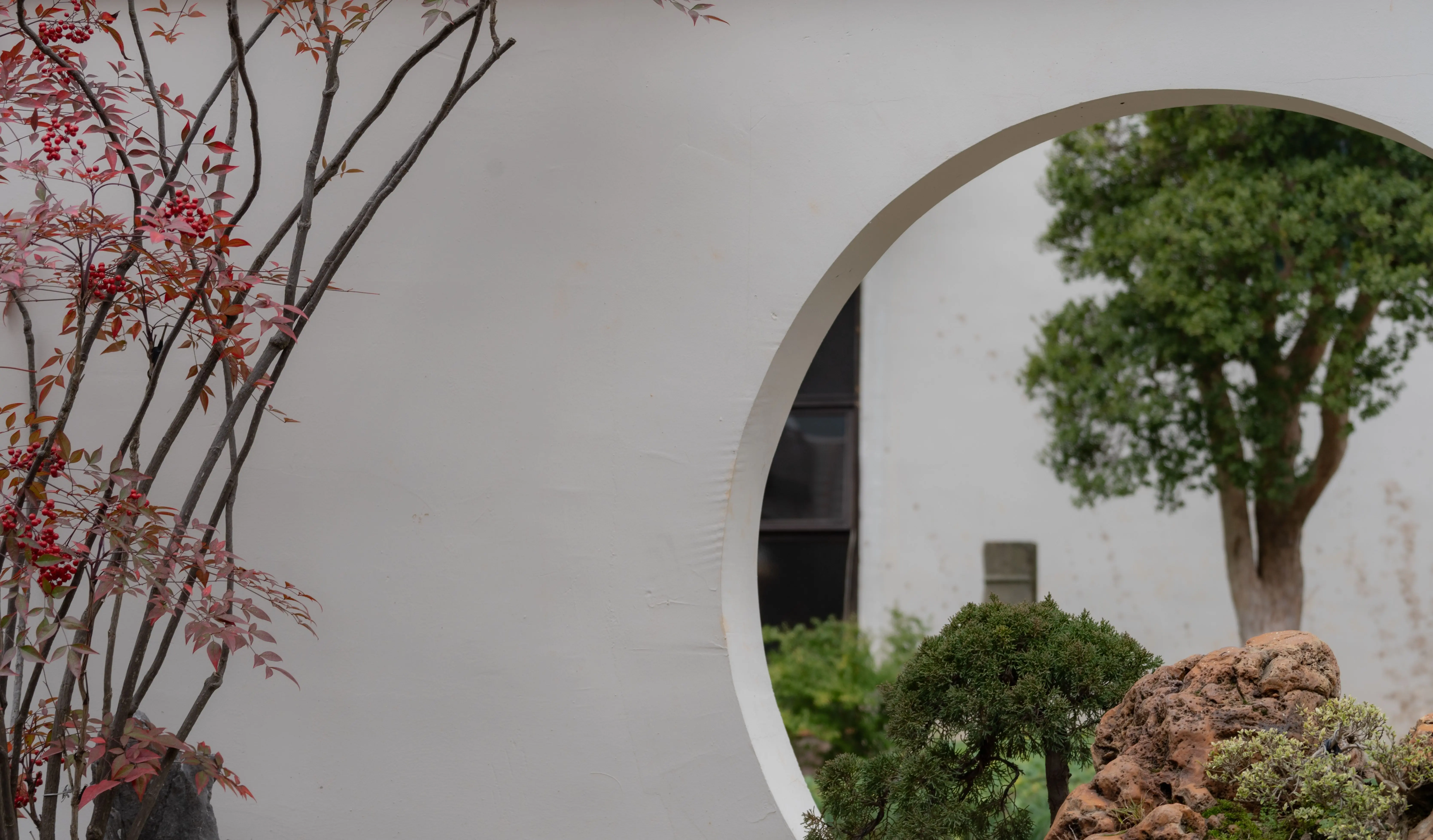 zone 5 perennials Peaceful garden scene featuring a round archway and lush trees.