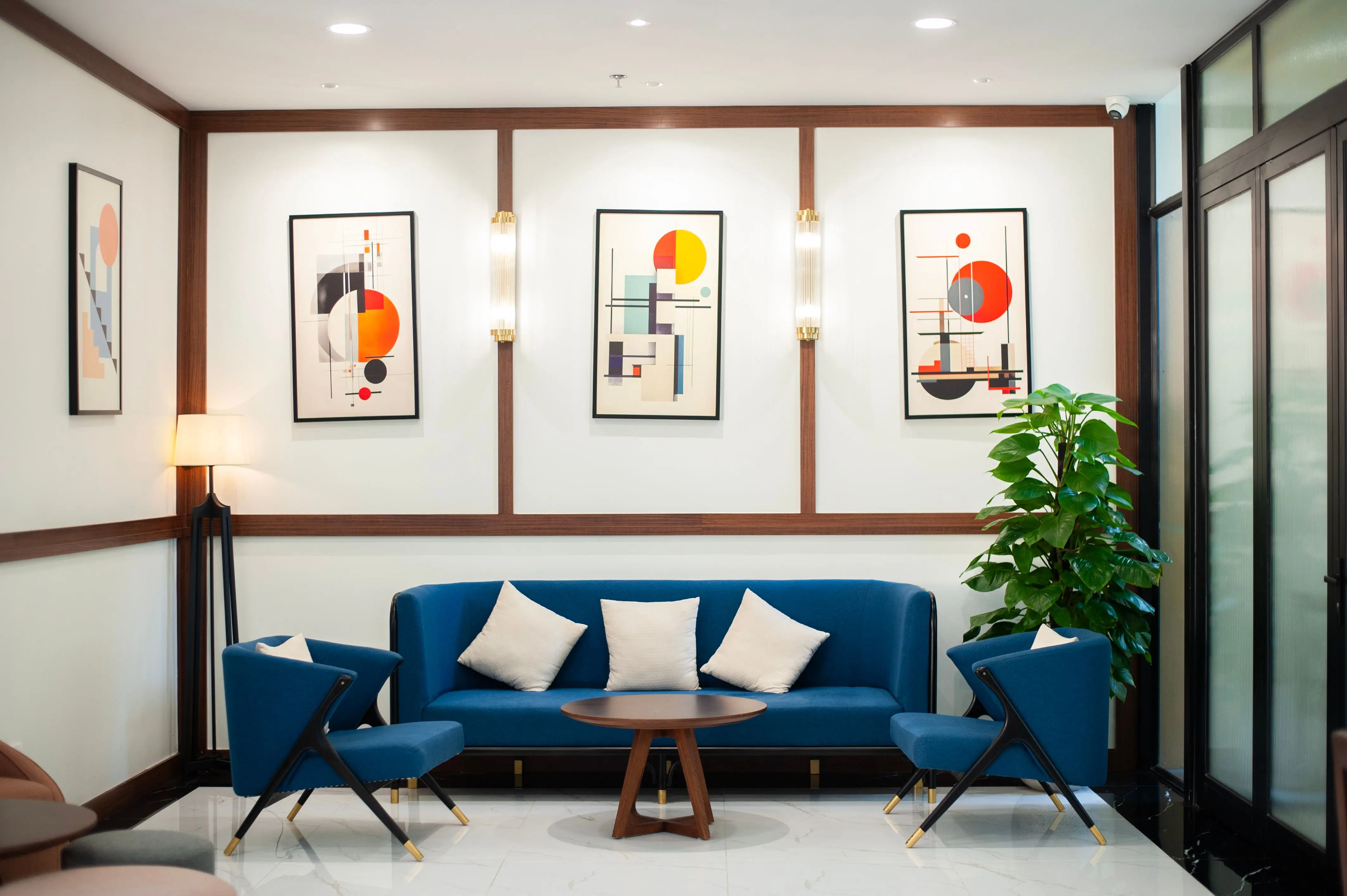 abstract prints Stylish modern living room featuring abstract art, blue seating, and indoor plant for a cozy atmosphere.