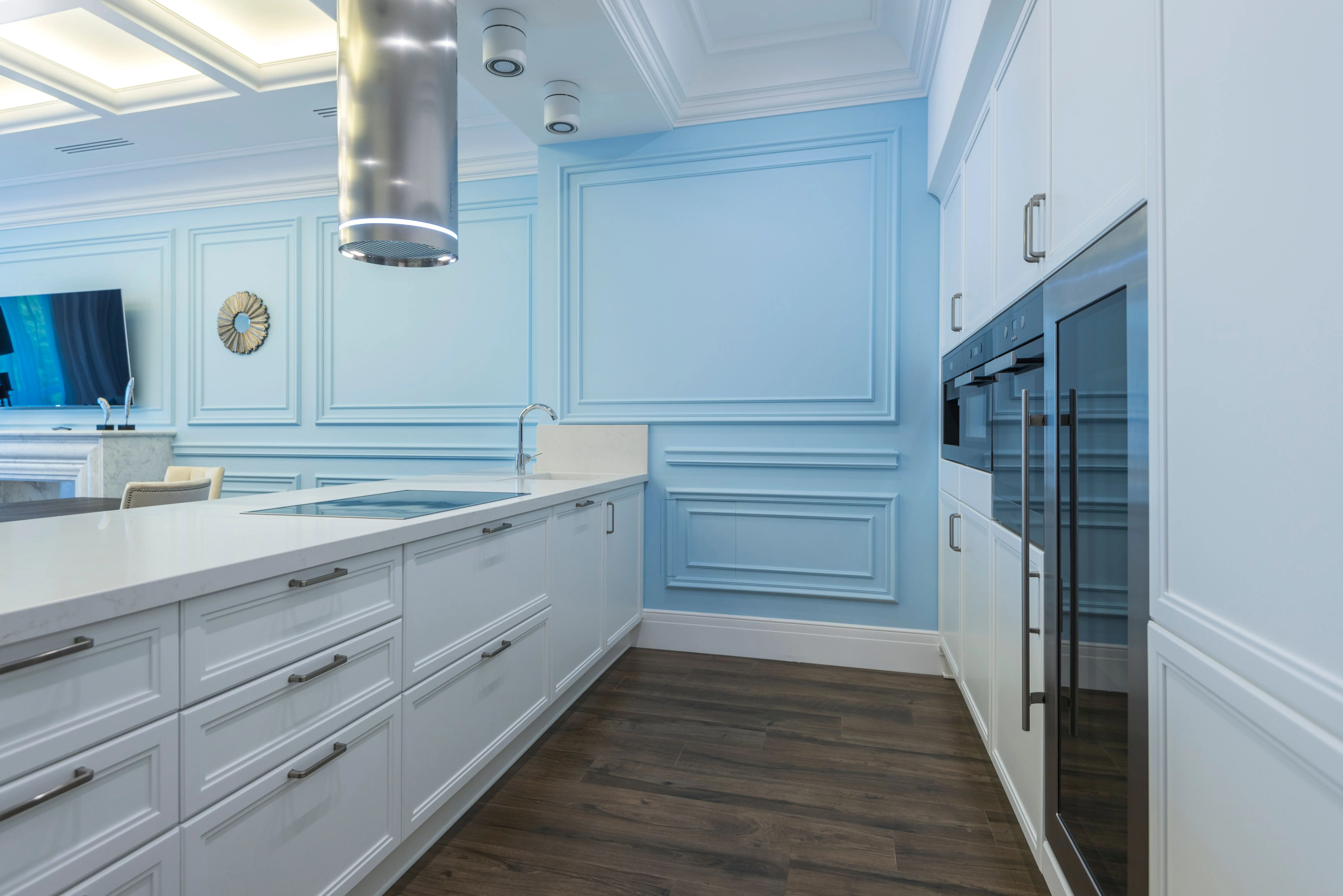blue backsplash Contemporary kitchen with blue panel walls and sleek white cabinets.