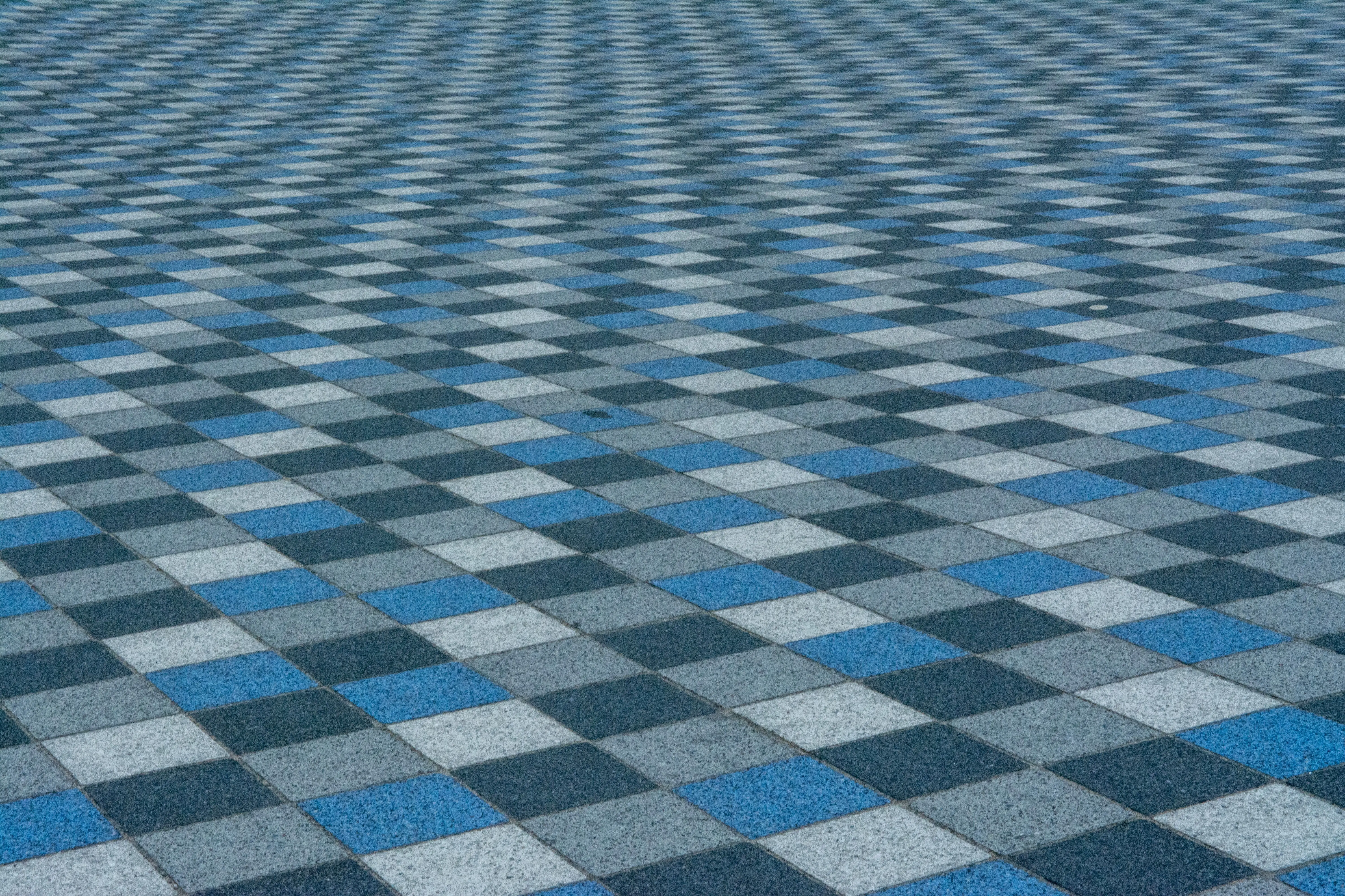 blue floor tile Vibrant blue and gray checkered pattern on urban pavement for modern design.